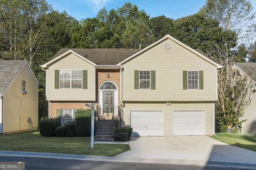 Recently renovated and move-in ready, 5937 Yellowood Ct is a 4-bedroom, 3-bath split-foyer home with modern updates and natural charm. The renovated kitchen features stainless steel appliances and stone countertops, complemented by updated fixtures throughout. The en-suite primary bath includes a picture window beside the tub that looks out into the trees, creating a peaceful retreat. Downstairs, a stunning fireplace adds style to the lower level's sleek design. Backing up to a treeline for added privacy, the home also offers a two-car garage and convenient access to interstates, the airport, and nearby College Park and Riverdale an area known for its vibrant community and easy access to everything Atlanta offers.