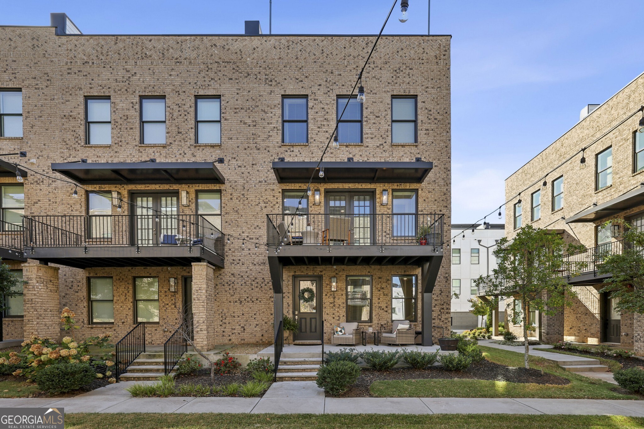 Priced Below Appraised Value! Gorgeous Brick End Unit Townhome nestled along the vibrant Westside BeltLine in the sought-after Ten29 West community   one of the few neighborhoods with Direct BeltLine Access! With the BeltLine at your doorstep and Mercedes-Benz Stadium just minutes away, this home perfectly blends modern luxury with unbeatable convenience. A Covered Front Porch welcomes you inside, where Abundant Windows, 10' Ceilings, and Hardwood Floors throughout create a bright, open layout. The Entry Level Bedroom with Ensuite Bathroom offers incredible flexibility   ideal for a Home Office, Guest Suite, or both thanks to the Murphy Bed setup. Upstairs, discover an Open-Concept Living Level designed for entertaining and everyday comfort. The Living Room features a Custom Accent Wall, while the Chef's Kitchen impresses with a Massive Quartz Waterfall Island, Beautiful Stained Cabinetry, Stainless Steel Appliances, and a Timeless White Subway Tile Backsplash. The Dining Room is full of natural light and opens through French Doors to a Private Balcony, perfect for morning coffee or al fresco dining. A Chic Powder Room on this level adds convenience, and Custom Built-In Cabinetry and Serving Counter provide a perfect setup for hosting. The Primary Suite is a luxurious retreat with a Double Stone Vanity, Glass-Enclosed Shower, and a Large Walk-In Closet. A Secondary Ensuite Bedroom completes the upper level, ideal for family or guests. Head up to the Private Rooftop Deck   a true showstopper! Enjoy City Views, a Partially Covered Lounge Area perfect for game days, Artificial Turf for Play, and plenty of space for a Dining Set or Outdoor Kitchen. An additional highlight includes a Two-Car Garage with Electric Vehicle Charger Outlet. Located just minutes from Downtown Atlanta, Georgia Tech, Mercedes-Benz Stadium, and the Westside Park, with easy access to Echo Street West, The Works, Interlock, and countless Shopping, Dining, and Entertainment destinations. Enjoy proximity to some of the Westside Districts best   from Marcel and Little Sparrow to Bar Blanc, Forza Storico, Jeni's, Sid Mashburn, and Perrine's Wine Shop. Experience Modern BeltLine Living at its best   Welcome to Ten29 West!