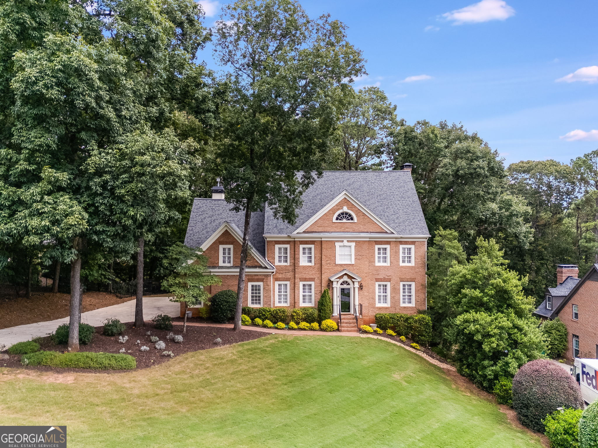 Welcome to this beautiful 5 bedroom, 4.5 bathroom executive residence located in a sought-after community with convenient access to major Atlanta roadways. Situated on a lush almost 0.5-acre lot, this home offers an exceptional layout designed for both everyday living and entertaining. Step inside the grand foyer leading to a formal dining room and a versatile office/sitting room. The open living room with fireplace flows seamlessly into the chef's kitchen, featuring a gas cooktop, abundant prep space, built-in desk, and breakfast bar overlooking the keeping room with a French-tiled fireplace. A sun-filled sunroom provides the perfect spot for morning coffee or afternoon relaxation. Upstairs, the spacious primary suite includes two custom walk-in closets, dual vanities, and a jetted soaking tub. Additional bedrooms are generously sized and well-appointed. The daylight basement features a private bedroom and multiple bonus living spaces, ideal for a home gym, playroom, or media area. Recent updates include fresh interior paint and new landscaping, ensuring this home is move-in ready.