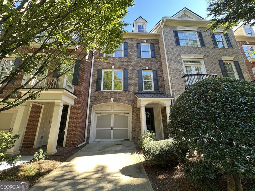 Unbeatable location! Just minutes from Alpharetta's most exciting dining, shopping, and entertainment, this stunning townhome puts you right in the heart of it all. Designed with style and comfort in mind, every detail shines from gleaming hardwood floors and elegant trim to custom lighting and thoughtfully desinged closets. Step inside through the welcoming foyer with direct access to the tandem garage. The main living level features a bright fireside family room with built-in shelving, a convenient office/study nook, and an open dining space that flows seamlessly into the kitchen. Your chef's kitchen is equipped with granite countertops, an island, stainless steel appliances,a gas range, and abundant cabinetry - perfect for everyday living or entertaining friends. Just off the kitchen, enjoy a private outdoor retreat for relaxing evenings. Upstairs, the primary suite offers a spacious sitting area framed by windows, a spa-inspired bath with dual vanities, a Jacuzzi tub, and a separate walk-in shower. A private secondary suite adds comfort and flexibility. Enjoy a low-maintenance lifestyle with incredible community amenities - pool, fitness center, clubhouse, and green space. Outdoor lovers will appreciate nearby Big Creek Greenway. Concerts, dining and shopping are just minutes away at Avalon, downtown Alpharetta and Ameris Amphitheatre. This isn't just a home - it's the lifestyle you've been waiting for.