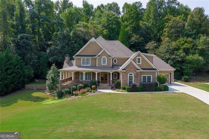 Must See Estate in Brooke Park! FABULOUS OWNERS' SUITE ON MAIN ON 1.17 ACRES! You'll love the beautiful drive through this neighborhood and to the doors of this private estate. Home features multiple nature trails, bubbling brooks, waterfalls and access to the Etowah River! This Prestine Executive Home immediately welcomes you with lush landscaping and a large wrap around porch leading to the front door. Inside the Gourmet Keeping Room, Kitchen with Stainless Steel Appliances and beamed Ceiling in the Keeping Room are impressive. This home features 2 Fireplaces, plantation shutters and a Luxurious Owners' Suite on Main with Trey Ceiling and Spa-like Bathroom. Spacious Secondary Bedrooms with new carpeting throughout. Flagstone Firepit Patio/Walkways, Stone Walls, Waterfall into Koi Pond and as an extra bonus, a newly added artificial turf and fenced back yard private oasis! Directly across the street you will find a Park and Neighborhood Trail next to the Etowah River! Large Daylight Basement ready for your finishing touches! 3-car Garage. Complete exterior newly painted with all woodwork sealed and windows inspected. Desirable Creekview School District! Amenities include Swim/Tennis/Playground/Nature Trails. New Neighborhood Entrance planned for 2022. Convenient to Canton Marketplace and 575!