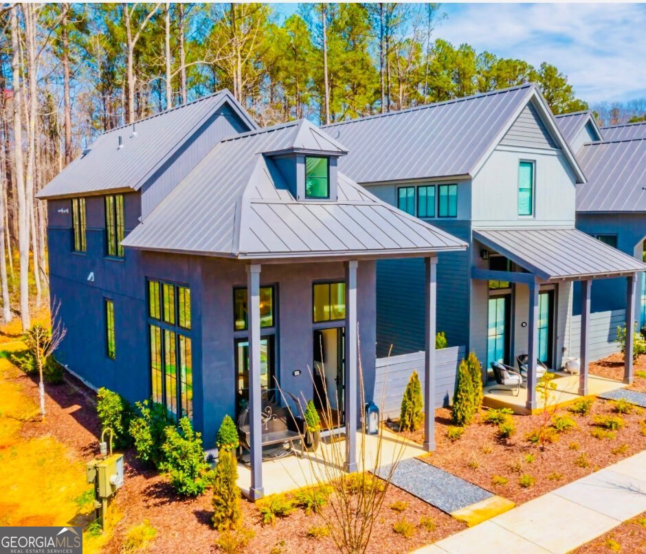 This Modern Shotgun Home is modeled after the classic Southern vernacular for efficient, smart living. It is being sold Fully Furnished and This home is Geothermal and EarthCraft certified, built by McKinney Builders and includes sustainable features and an energy-efficient layout. The open floor plan includes a room to the back of the home, perfect for a second bedroom or office, and the master bedroom on the second story with a loft to overlook the kitchen, dining and living space. Enjoy the outdoors with your own side yard.