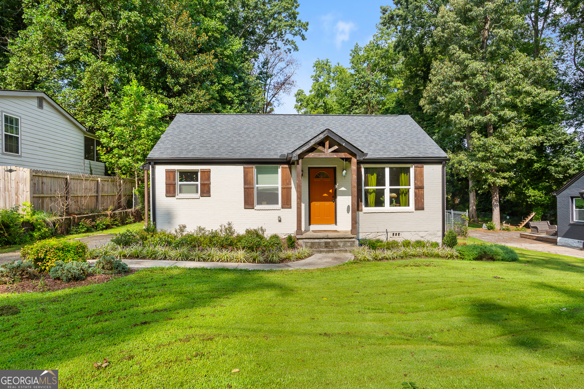 Welcome to your charming Decatur bungalow-fully renovated from the studs out and designed with today's lifestyle in mind. Perfectly located near downtown Decatur, East Lake Golf Club, I-285 & I-20, this home is the total package: character, convenience, and craftsmanship. Inside, you'll find a bright, open layout with new hardwood floors, designer touches, and abundant natural light. The kitchen shines with antique white cabinetry, stainless steel appliances, quartz countertops, and a marble-inspired backsplash-a clean, timeless look for cooking and entertaining. This smart floor plan was reimagined from a 2/1 to a true 2/2, giving you a spacious owner's suite with vaulted ceilings, spa-like shower, and dedicated laundry space. Every system has been updated, including the roof, HVAC, water heater, and windows, so you can enjoy peace of mind for years to come. Step outside to a large, fenced backyard with plenty of space to play, garden, or host friends. A roomy outdoor shed offers bonus storage or potential workshop vibes. With its classic all-brick exterior, fresh landscaping, and a driveway that makes parking a breeze, this home checks every box.