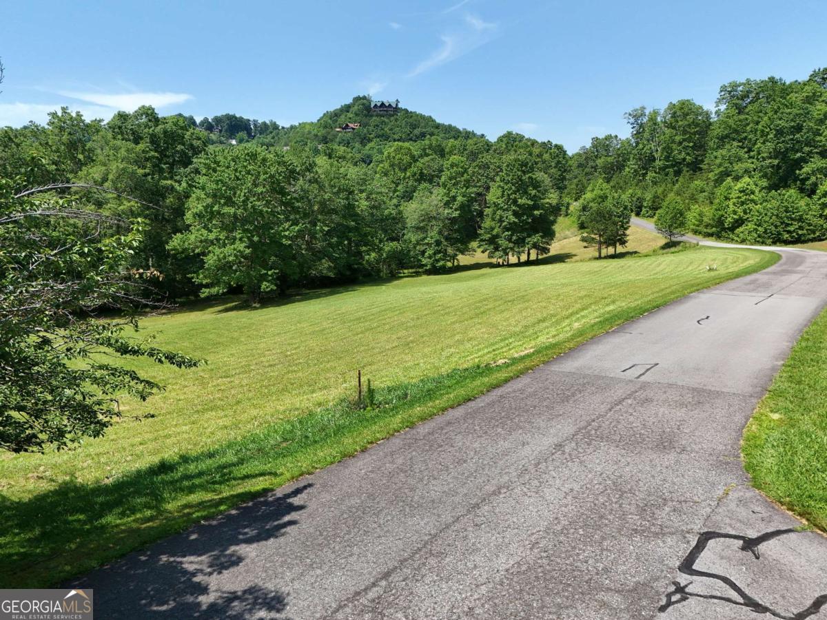 Gorgeous 2.46-Acre Lot in Meadow Brooke Subdivision! Located just minutes from downtown Hiawassee and beautiful Lake Chatuge, this gently sloping lot offers the perfect setting to build your dream mountain home. Meadow Brooke is a prestigious gated community featuring a clubhouse, swimming pool, and tennis court for residents to enjoy. This lot is already approved for a four-bedroom septic permit on file and even includes a natural spring on the lower portion of the property-adding to its serene charm. All paved roads, public water and underground electric. Don't miss this opportunity to own in one of the area's most desirable neighborhoods with easy access to Lake Chatuge, dining, and shopping.