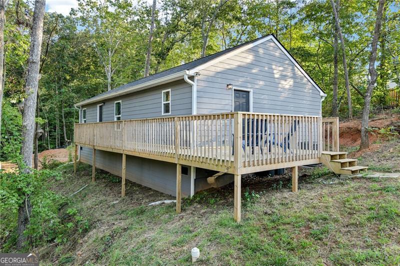 MY WONDERFUL CLIENTS ARE OFFERING THEIR NEARLY NEW 3/2 RANCH HOME IN LAKE LANIER COMMUNITY!! This cozy home is only two years old & low maintenance making it Perfect for first-time homebuyers or those seeking to downsize. You'll enjoy the open concept w/laminate flooring throughout most of the home & vinyl in the bathrooms & laundry. Large master bedroom & walk-in closet. Nice deck provides access to both the front and side entrances & provides the perfect place to enjoy your morning coffee. Power line on one side of home might be a negative to some, but it provides alot more privacy & space on the side you park & play. Residents of the desirable Surfside Club Estates community get to enjoy access to their private boat ramp, a HOA managed water system (so no water bill) & even more importantly you'll crave the peacefulness you'll experience while driving through the neighborhood on your way home. Only 1 1/2 miles from I-985 and less than 10 minutes to Northeast Georgia Medical Center, Kroger & more.