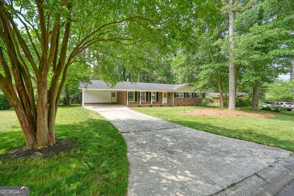 Welcome to your dream home in the heart of Marietta! This beautifully maintained 3-bedroom, 2-bath ranch offers comfort, style, and versatilityCocomplete with a finished basement perfect for entertaining, a home office, or extra living space. Step inside to find a bright living area with fresh interior paint, hardwood floors, a cozy fireplace, and plenty of natural light. The spacious kitchen features stainless steel appliances, ample cabinet space, and a breakfast nook overlooking the backyard. The main level also includes a primary suite with a private bath and two additional bedrooms. Downstairs, the finished basement expands your living options with a bonus room, tons storage and a boat doorCoideal for a game room and workshop. Enjoy GeorgiaCOs beautiful seasons on the deck overlooking a private, fenced backyardCoperfect for relaxing or hosting gatherings. Located in a friendly neighborhood with easy access to schools, parks, shopping, dining, hospitals and highways, this home provides the perfect blend of privacy and convenience. Optional HOA available for neighborhood socials. DonCOt miss the opportunity to own this beautiful brick ranch home.
