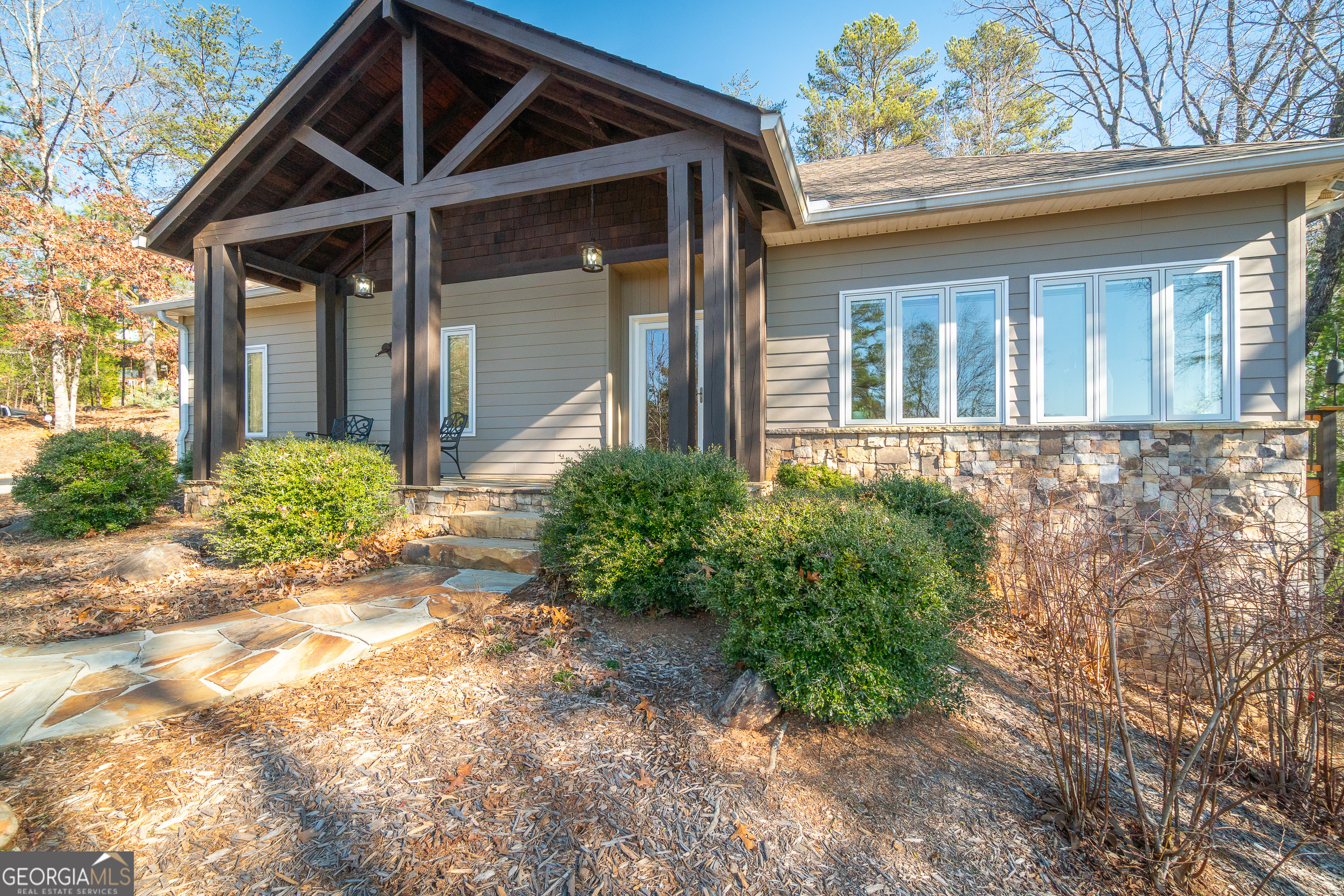 Surpassing your expectations from the ground up! You are sure to realize the hidden potential of this unique home. It's YOUR turn to appreciate the many special features of this impressive 4 BR 2.5 bath residence. Unbelievable price of less than $159.50 Per Heated Square Foot for this home with top-of-the-line construction. These owners put their heart and soul into designing and building this custom home using highly efficient Polysteel Construction (Polysteel goes up from basement level to ceiling level of the main floor) providing superior insulation, sturdy thick walls complemented with Hardie Plank exterior siding. Exceptional Pella Casement Windows and Pella Doors have integrated blinds. Enjoy a beautiful view of Yonah Mountain right from the stone front porch, living room or from the spacious wooden deck that includes a screened in porch accessed from the deck or the French doors from the primary bedroom. The living room features a stacked stone gas log fireplace. A separate dining room has hardwood floors and could easily be utilized as an additional bedroom, or office. The large open kitchen has custom cabinets, tile backsplash and breakfast bar area, but add to all that, a pantry cabinet plus a pantry closet. All appliances included! This comfortable, affordable home can be a full-time residence or an investment property for Short Term Rental. Enjoy the SAFETY of this QUIET, LOW MAINTENANCE property with no opportunity for TERMITES! Need more? The well-planned terrace level has 3 generous bedrooms, 2 of which open onto the patio, a full bath, a wet bar, an office, a storage room, and a workshop! The storage room & workshop are heated & cooled; the workshop could also be finished into an additional bedroom, craft room, or rec room. The list goes on, but to name just a few more special features, we must mention the WHOLE-HOUSE TANKLESS WATER HEATER, Central Vacuum, WIDE DOORS and hallways, HVAC System with 3 Zones, mature native landscaping with blueberry bushes and many wildlife resistant plantings. ALL of this on TWO beautiful lots in the Innsbruck neighborhood, near the popular city of Helen and many other NE Georgia attractions. The two lots have been combined under the POA so you pay only one POA fee!