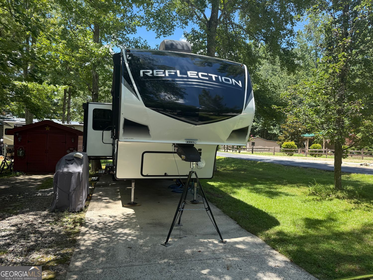 One of the most inviting campers you will ever walk into. High ceilings beautiful finishes great floor plan. Everythging you need and in one of the best campgrounds around. This 33 ft Camper that is just like it came off the showroom floor. It is immaculate and so pleasant on the inside sits on a corner lot conveniently located close to the amenities.There is a storage building with electricity to put all of your extra things in. The owner is including some things that you would not know you needed until you do with the sale of this camper. This is a really outstanding location and the lot is level and easy to maintain.