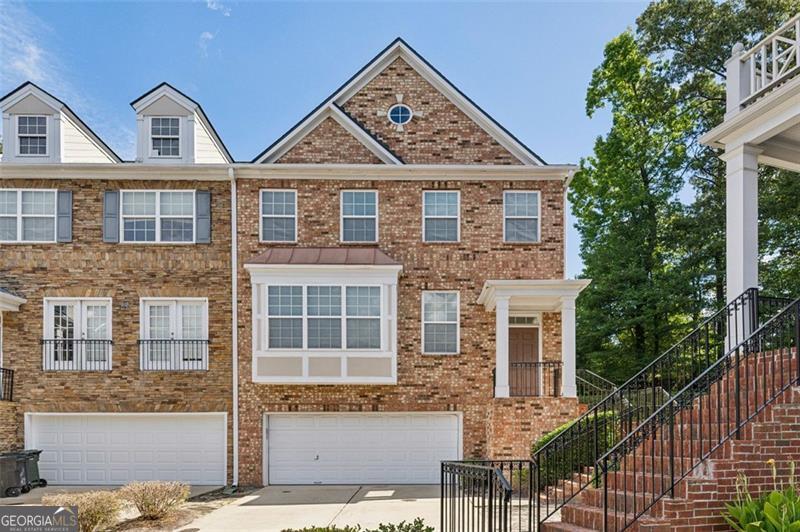 Bright, spacious, and ideally positioned-3917 Old Atlanta Station is the end-unit townhome you've been waiting for. With windows on three sides, this home is bathed in natural light and offers an airy, open feel across all three levels. Located in a quiet, well-kept community in the heart of Vinings, you're minutes from major highways, The Battery, West Village, and top-tier restaurants and you have DIRECT access to the 61 mile, tree-canopied Silver Comet Trail that will connect to the Beltline, downtown ATL and throughout Cobb County. Bike, stroll, walk, or run and leave your car behind. Inside, enjoy high ceilings, warm hardwoods, and generous living spaces. The main floor features a well-equipped kitchen with granite countertops and stainless steel appliances, flowing into a large living room with a double-sided fireplace and built-ins. The separate dining area and rear deck make entertaining easy and comfortable. Upstairs, the oversized primary suite includes a walk-in closet with custom shelving, a soaking tub, double vanity, and separate shower. A second bedroom with en suite bath and laundry room complete the upper level. The terrace level offers even more flexibility with a full bath, bedroom, and bonus space perfect for a home office, media room, or guest suite. Additional highlights include a two-car garage, low-maintenance exterior, and the excellent natural light throughout thanks to the end-unit layout. The Silver Comet Trail, Beltline access, and major employers are all just minutes away. Food lovers will appreciate the unbeatable proximity to local favorites like South City Kitchen Vinings, Mezza Luna Trattoria, Jim 'N Nick's Bar-B-Q, Muss & Turner's, Canoe, and Otter's Chicken-just minutes away. It's the ideal combination of generous living space, prime location, and rare value in Vinings. Opportunities like this don't come around often-schedule your private tour today!