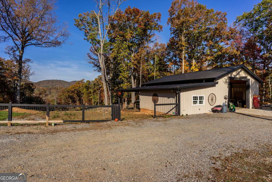 Gorgeous 1.53-acre lot with barn/storage building in the desirable Crane Creek Subdivision of Towns County, located in the charming mountain town of Young Harris. Gently sloped with a blend of mature trees and light clearing, this property offers a peaceful, partially wooded setting with beautiful mountain views-perfect for a weekend escape, future build, or creative project. The site adds character and function, offering space for storage, a workshop, or a unique conversion. Adjoining properties: 964 Conners Ridge Rd and 130 Springwood Lane are also available for purchase, giving you the option to expand your vision. Ideally located just minutes from Blairsville, Hiawassee, and Murphy, you'll enjoy close proximity to lakes, hiking trails, charming local restaurants, and all the outdoor adventures North Georgia is known for. A rare opportunity to own a piece of the mountains with both beauty and potential.