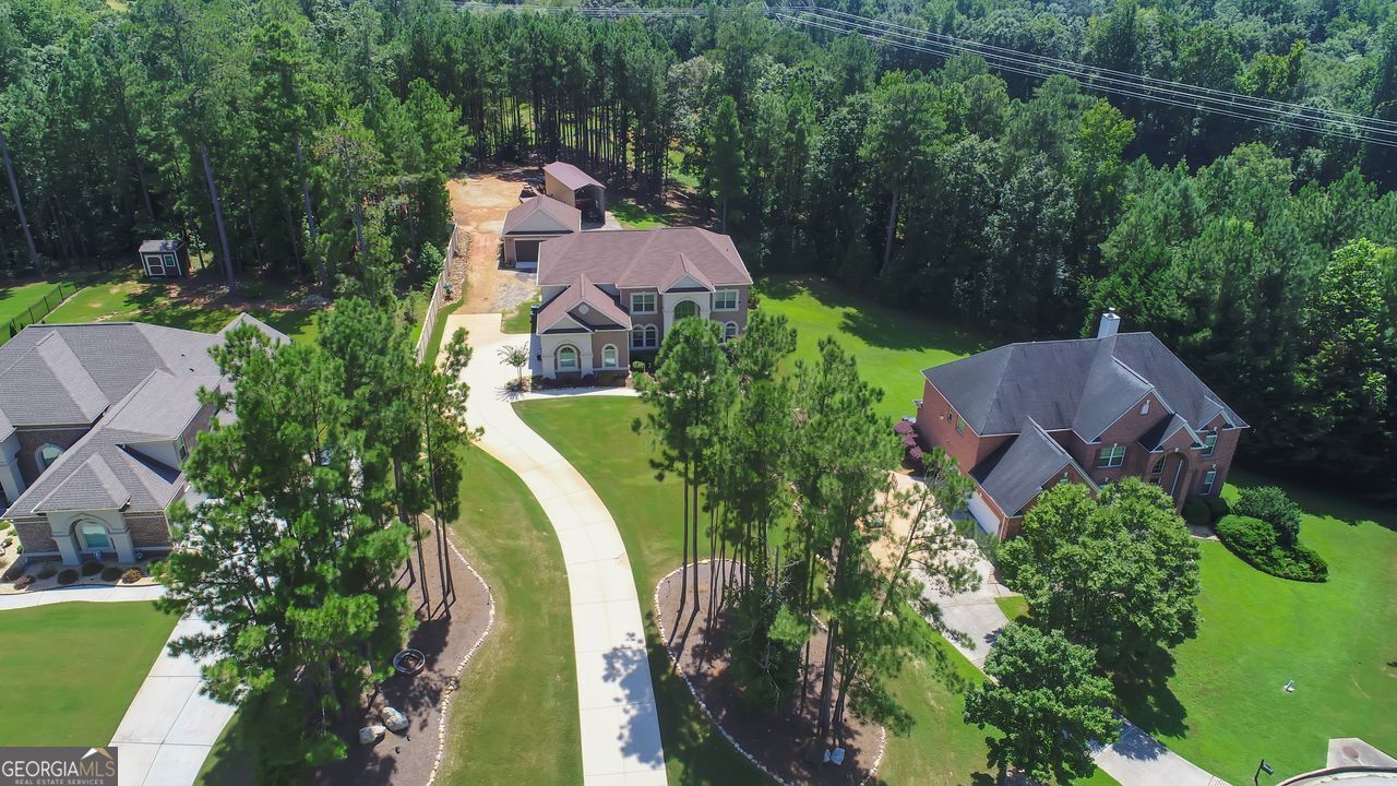Step into an unparalleled realm of possibilities at 3238 Ashmore Court! Designed for the most discerning of buyers, this property features 5 bedrooms, 4.5 bathrooms, 3 car attached garage with an additional detached 2 car garage and meticulously landscaped grounds with an irrigation system. Everything you desire on one acre with the OPTION TO PURCHASE MORE ACREAGE! The estate also includes an RV/ATV/trailer/boat shed to house all of your outdoor toys and machinery, offering the perfect blend of seclusion and accessibility. Be welcomed by a grand two-story foyer into the main level, gleaming with natural light. The two story family room looks onto the chef's kitchen with an abundance of storage. Off the kitchen you'll be drawn out to a covered retreat featuring a cozy fireplace, perfect for entertaining. Surround sound through out the home and attached garage. Spacious bedroom and bathroom on main floor with an additional half bath. Upstairs host two secondary bedrooms, a full bathroom, one ensuite bed and bath, a laundry room and a palatial owner's ensuite with a jacuzzi tub and an enormous closet that will blow your mind! All atop a full basement. Buyer has the ability to purchase more acreage if desired. Don't miss out on this opportunity, call the listing agent to schedule a tour of this beautiful home.