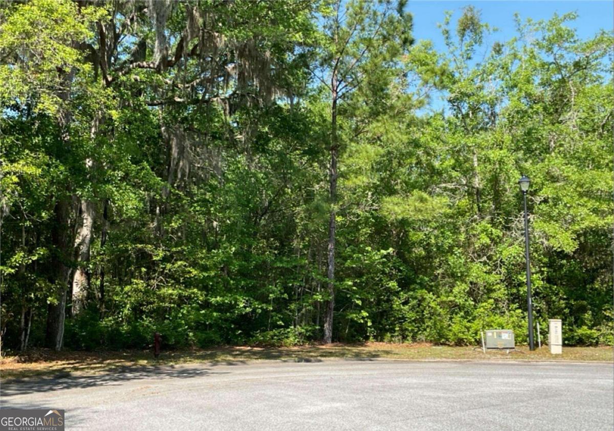 Discover a serene retreat with this charming 0.71-acre wooded lot nestled within a gated community. Embrace the tranquility of nature while enjoying the security and exclusivity of this well-maintained neighborhood. This generously sized parcel offers a perfect canvas for your dream home, surrounded by lush, mature trees that provide both privacy and a picturesque setting. The lot's gentle topography and natural landscape create an ideal environment for designing a custom residence tailored to your preferences. Imagine waking up to the sounds of birds chirping and the rustling of leaves. This lot provides the flexibility to build a personal home that harmonizes with its natural surroundings. Don't miss this unique opportunity to secure a slice of paradise within a sought-after community.