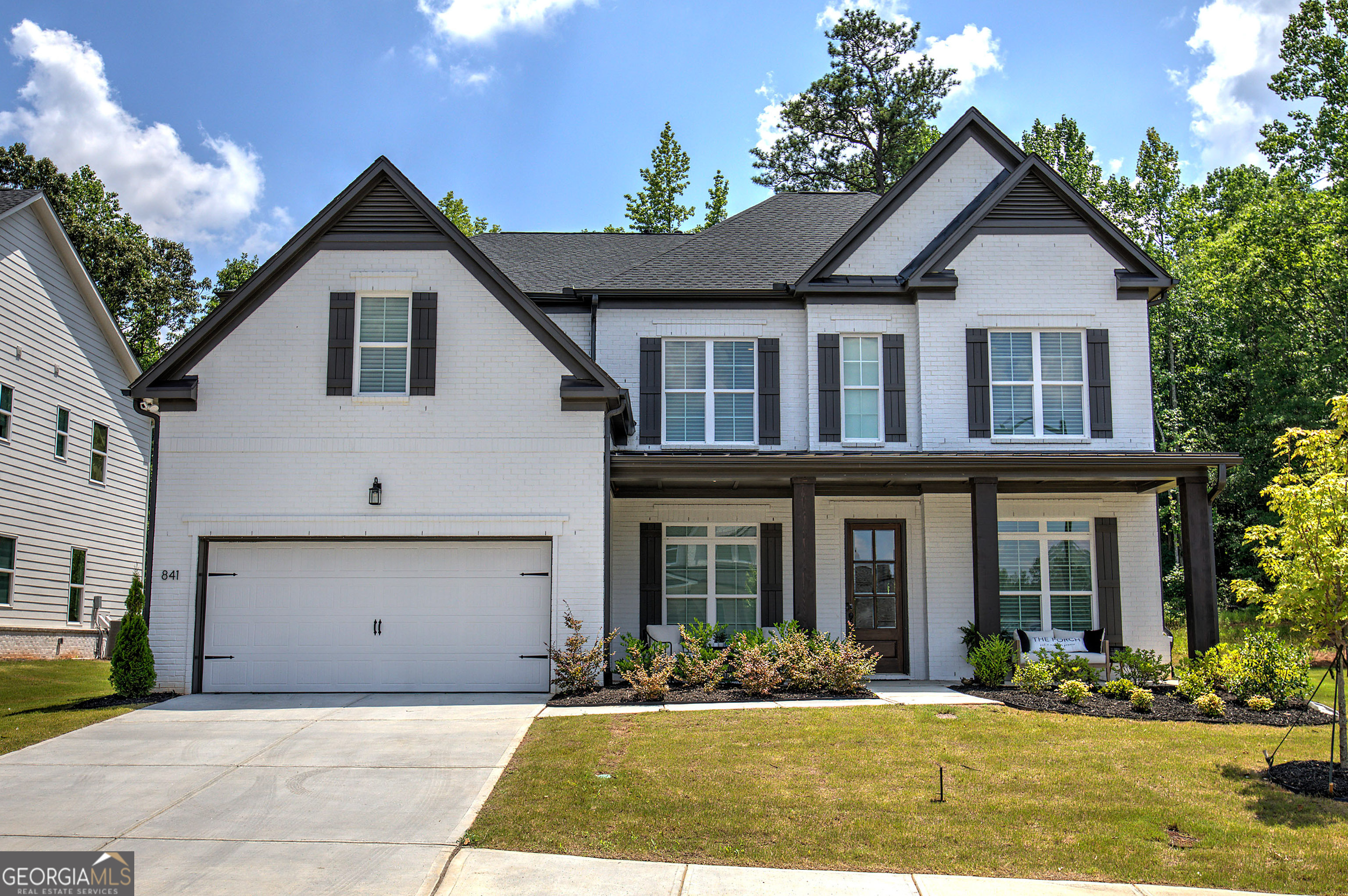 Welcome to this stunning, custom-crafted residence nestled on a desirable northeast-facing lot in the sought-after Vista Ridge subdivision of Woodstock. This 5-bedroom, 5.5-bath masterpiece blends refined elegance with everyday comfort, offering exceptional upgrades and thoughtful design throughout. Step inside to discover hardwood flooring throughout all main living areas, a seamless open floor plan, and a flood of natural light. The gourmet kitchen is the heart of the home, boasting luxurious Silestone Et Dor countertops, an oversized island, gold hardware, double ovens, a pot filler, and top-of-the-line JennAir appliances-perfect for both casual dining and entertaining. A butler's pantry adds convenience and charm, connecting the kitchen to a formal dining area. Every bedroom is a private retreat, complete with its own en-suite bathroom. The downstairs guest suite features a walk-in shower, ideal for visiting friends or multigenerational living. The home office offers a quiet, stylish workspace, and custom light fixtures throughout add a sophisticated touch. Enjoy a level backyard, perfect for outdoor entertaining or play-all framed by the tranquility and beauty of this prestigious neighborhood. Neighborhood amenities offer a relaxing pool, clubhouse, and playground. Don't miss your chance to own one of Vista Ridge's finest homes-where luxury, location, and lifestyle come together seamlessly.