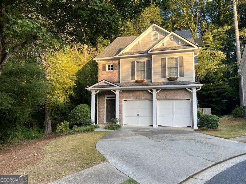 Welcome to 6000 Hunter Hall Ct, a private retreat on a cul-de-sac in one of Norcross's most charming hidden communities. With only 12 homes on the street, this residence enjoys the most private lot, bordered by woods on two sides. You're just a short stroll from Downtown Norcross, parks, concerts at Thrasher Park, local dining, and the family-friendly Cultivation Brewery, a perfect blend of seclusion and walkability. Inside, the home is fully renovated and move-in ready, with fresh interior and exterior paint, new carpet, updated hardwoods, and modern smart-home features. The open-concept living area centers around a cozy gas fireplace and flows into a custom designer kitchen with quartz countertops, soft-close cabinetry with pull-out drawers, stainless appliances, and a large entertaining island. The owner's suite features a spa-like walk-in tile shower, dual vanities, and built-in tablets. Two additional bedrooms plus an updated bath offer flexibility for family, guests, or office use. Step outside to a paver patio and wooded backdrop, creating a private, low-maintenance yard rarely found this close to downtown. Enjoy friendly neighborhood deer strolling by or listen to the birds while sipping your morning coffee. With landscaping included in a low HOA, at a fraction of the cost of nearby townhomes, you'll enjoy convenience without compromise. This home delivers the perfect mix of privacy, walkability, and modern living, fully turnkey and ready for you to move in and start enjoying immediately - a standout opportunity in Historic Norcross.
