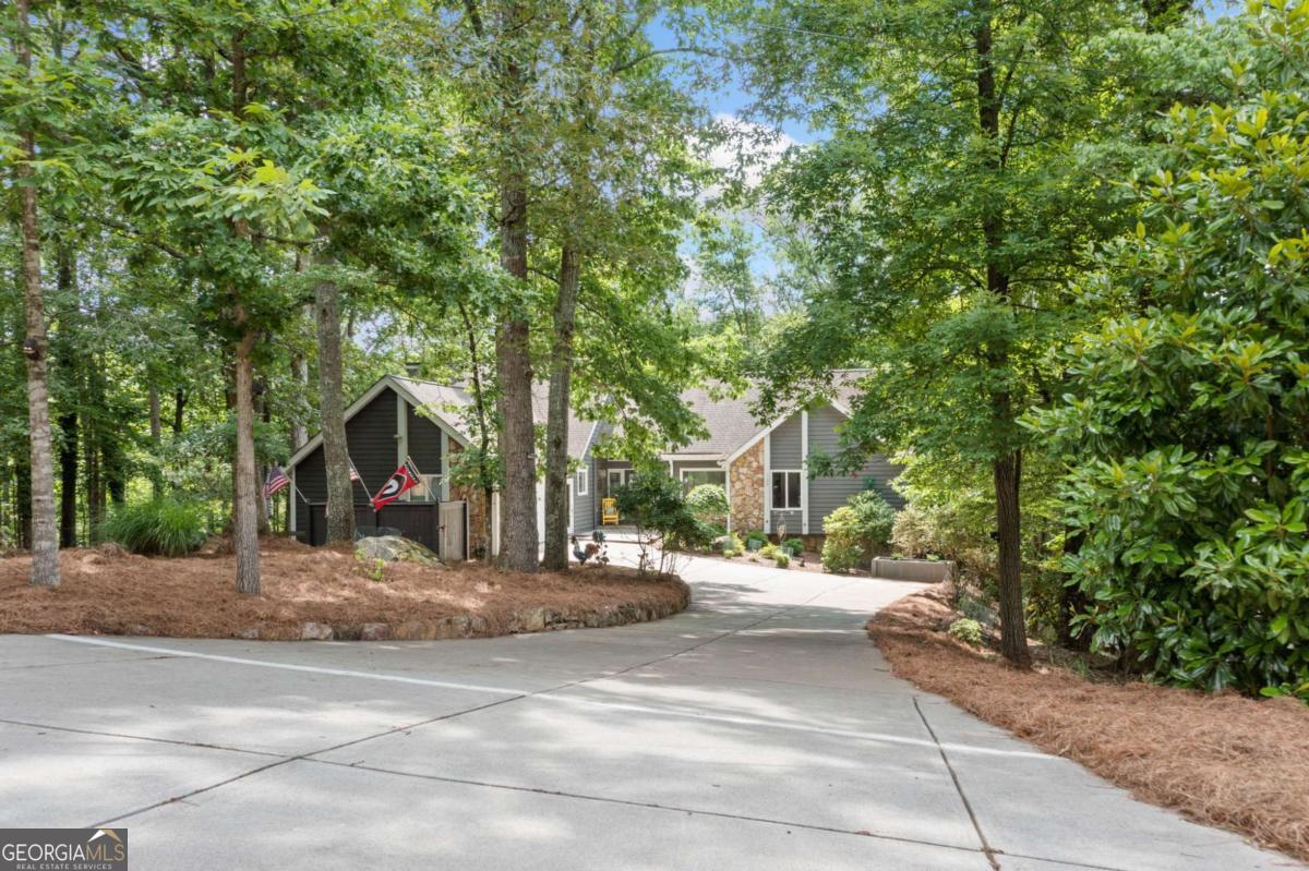 Incredible Fully Renovated Lake Front Home. This Beautiful Ranch Over a Full Finished Walkout Terrce Level Sits a Private Wooded Lot with 157 Feet of Water Frontage on Lake Chickasaw, a Private Lake Inside the Community of Lake Arrowhead. Enjoy a Low Maintenance Landscaped Yard with Easy Walk to the Dock. A Level Driveway Leads to the Home and a Covered Stone Front Poch with Leaded Glass Double Doors Welcomes You Home. Once Inside the Two Story Entry, the Great Room with Vaulted Ceilings and Exposed Beams Draws You In. A Full Wall of Windows Overlooks and Expansive Deck and Lake Views. Stunning Kitchen with Beautiful White Cabinetry Showcases Glass Fronts, Lit from the Inside! Open Concept Dining Area Offers Views to the Kitchen, Great Room and Lake! Well Equiped Laundry Room Provides Additional Pantry Space, Coffee Bar and Beverage Fridge! There is a Dedicated Home Office with Private Half Bath and Full Closet that Would Transition Easily to a Bedroom. This Incredible Home has Two Primary Suites with Private En Suites! One has Vaulted Ceiling with Exposed Beams and Access to a Private Three Season Room with Outdoor Fireplace! The En Suite Offers a Gorgeous Spa-like Tile Shower, Double Vanity and Luxurious Soaking Tub. The Second Primary Suite is Impressive with Access to Private Three Season Room Overlooking the Lake. The Ensuite Includes A Beautifully Custom Tiled Shower with Seamless Glass Door. The Fabulous Finished Terrace Level Provides a Second Living Area with Rustic Stone Fireplace and Access to a Covered Deck that Runs the Entire Length of the Home! Two Guest Bedrooms are Ideal for Overnight Lake Guests. A Full Bath Ensures Privacy for All. The Second Kitchen with Double Ovens is Great for Entertaining and Large Friend and Family Gaterinngs. A Hobby/Game Room and a Home Gym Offers Plenty of Options for Everyone. There is Also a Large Unfinished Workshop/Game Room and Even More Starage Space. Enjoy Sitting by the Firepit with Beautiful Views or Head Down to the Dock with Deep Water for a Swim or Boat Ride! Come see for Yourself and Start Imagining the Memories to be Made Here. Priced Thousands Below Recent Appraisal. Most of the Furnishings are Included. Please Ask for a Detailed List.