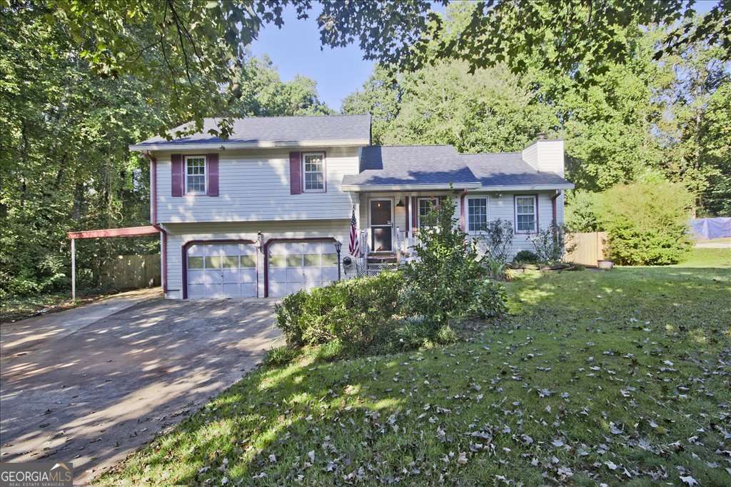 Charming 3 Bedroom, 2 Bath Home on Over Half an Acre in Acworth! Welcome to this beautiful home featuring a new roof, new flooring, and vinyl windows throughout. Situated on a level, fenced half-acre lot, this property offers privacy, space, and convenience with no HOA-all just minutes from downtown Acworth. Step inside to a warm and inviting family room with a stunning stone fireplace, perfect for cozy evenings. The home also features a formal dining room and a bright sunroom/den with large windows and a ceiling fan, ideal for morning coffee or a relaxing reading nook. The master suite includes a private full bath, while two additional bedrooms share another full bath, offering plenty of space for family or guests. Outdoors, enjoy your very own serene koi pond just off the front porch, complete with a cascading waterfall, natural stone edging, and lily pads-a tranquil retreat in your own yard. In the back yard enjoy the peach, apple trees and all the blooming flowers. A long driveway leads to an attached 2-car garage and carport, providing ample parking and storage options. This home combines comfort, charm, and convenience-making it a true gem in a sought-after community.