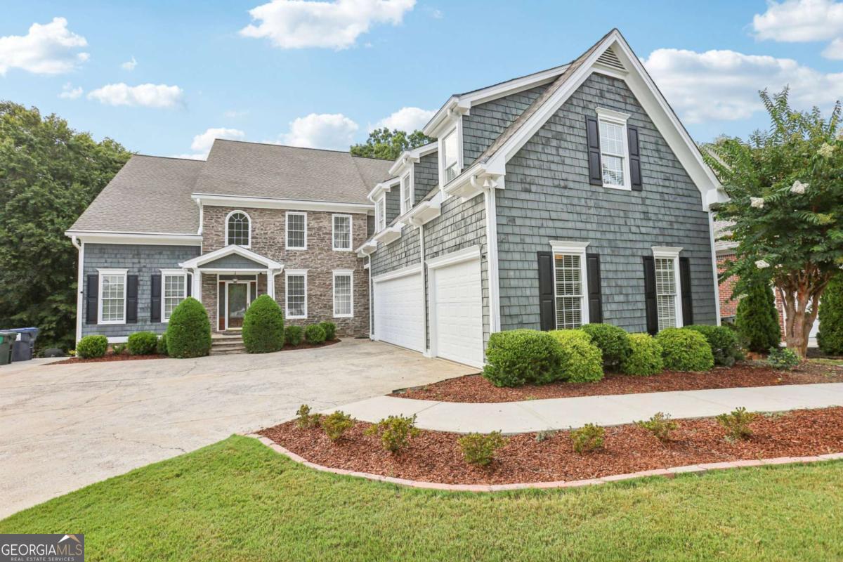 Discover an extraordinary 8,999 square foot sanctuary perfect for large families, where luxury meets comfort in the heart of Brookstone, one of the county's most prestigious communities. This magnificent 7-bedroom, 6.5-bathroom estate graces the 13th fairway of the renowned golf course, where emerald greens and mature landscaping create a breathtaking backdrop for sophisticated living. From the moment you arrive, the home's impressive presence captivates with its timeless architectural elegance. The side-entry three-car garage provides both convenience and aesthetic appeal, while rich hardwood floors flow seamlessly through sun-drenched spaces adorned with premium two-inch faux wood blinds that filter natural light to perfection. The heart of this exceptional property features three magnificent owner's en-suites, each a private retreat with luxurious bathrooms crafted to exquisite perfection and spacious walk-in closets. A beautifully appointed junior suite with an over sized closet ensures every guest experiences five-star comfort. Remarkably, the home offers a master bedroom on every level, providing incredible versatility for any lifestyle need. The gourmet kitchen stands as a testament to culinary excellence, seamlessly flowing into the dramatic two-story family room where gatherings become cherished memories. Upgraded stainless steel appliances, gleaming granite counter tops, and a substantial center island create a chef's paradise, while the generous breakfast room and walk-in pantry add both functionality and grace. The upper level's expansive loft area provides perfect space for quiet relaxation or lively entertainment. The nearly 3,000-square-foot finished basement transforms ordinary living into something truly extraordinary. This incredible space embraces multi-generational living with its second fully-equipped kitchen, allowing families to gather while maintaining independence. The custom home theater promises countless evenings of cinematic luxury, while the spacious family room, private office, and separate lounge areas provide endless possibilities. The distinctive man cave, complete with warming fireplace and attached bathroom, offers the perfect retreat. Outside, your private oasis awaits with a sparkling pool surrounded by meticulously maintained landscaping and the stunning natural beauty of the golf course's lush greenery. This outdoor sanctuary provides the perfect setting for both peaceful reflections and memorable entertainment. Living in the prestigious Brookstone community means access to the county's finest schools and exclusive country club amenities including championship golf, swimming facilities, tennis courts, and a vibrant social calendar. Every bathroom throughout this remarkable home has been customized to perfection, while thoughtful details demonstrate the attention that sets this property apart.This exceptional estate represents a rare opportunity to own something truly special-a place where comfort meets sophistication, and where every day feels like a retreat to your own private resort.