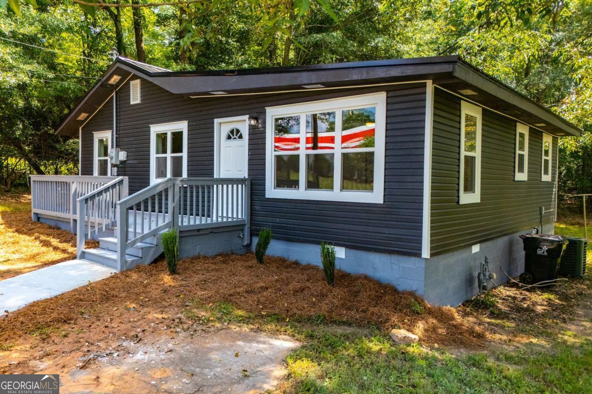 Fantastic renovation so close to the Interstate (I-20 Exit 19) but still with great privacy! 2 generous sized bedrooms and 2 full baths plus a great open floor plan den/kitchen. Kitchen in newly remodeled with granite countertops, new cabinets, and stylish fixtures. Entire house has been repainted, has new flooring, large front deck and back deck, new bathrooms, & new windows. This one is move in ready without you lifting a finger and is priced for affordability.