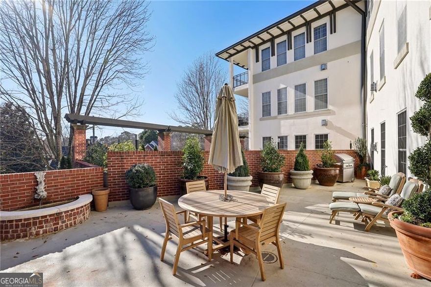 This beautifully renovated end unit offers a blend of modern luxury and comfort with an abundance of sunlight streaming into each room. Every inch of this home has been updated or refurbished. The kitchen has been transformed by the addition of a pass-through window to the living and dining space, brand-new KitchenAid appliances including side-by-side refrigerator/freezer and 5 burner gas range, a custom backsplash, the re-designed cabinetry with new pulls, pull-out drawers installed, plus added lighting and new Antico granite countertops for easy prep space. There is space in the kitchen for a bistro table and chairs. The Shaw engineered hardwood floors, set on the diagonal, add a touch of elegance throughout the space, complemented by stylish new light fixtures, added recessed lights and detailed crown and base molding. The living room walls are adorned with premium Farrow and Ball paint, giving the home a sophisticated feel along with the new fireplace and marble hearth and surround to create a cozy atmosphere, perfect for chilly evenings. The bedroom features a rich green Farrow & Ball paint color, thick window drapes, and a new ceiling fan. The bathroom features a high vanity counter with luxurious white granite, Restoration Hardware pivot mirror, and hardware components, a newly tiled shower with herringbone marble ceiling plus two seamless glass doors along the new air-jet bathtub, ideal for relaxing after a long day. Custom California Closets built-ins help maximize storage in the closet. From the dining room or bedroom, step outside to a large terrace, complete with a tranquil fountain and high-quality Kingsley Bate teak furniture, included with the sale. This outdoor space is perfect for entertaining, pet play space, or simply enjoying a peaceful moment. The space includes landscape lighting, a gas hookup for the grill and water spigot for your garden. The water heater, heating/cooling systems and space-saving LG washer/dryer combination unit are all brand new. Each of the double-sash windows has been refurbished for smooth operation with new screens installed. The building amenities include gated entrances, plenty of guest parking, a concierge on duty 7 days a week, fenced property, a designated dog area, large green space, a pool, exercise room, plus easy access to the restaurants and stores of the West Paces Ferry shopping district and easy access to I-75. This unit includes an assigned parking space in the secured parking garage as well as a private, secured storage room. *more photos soon*