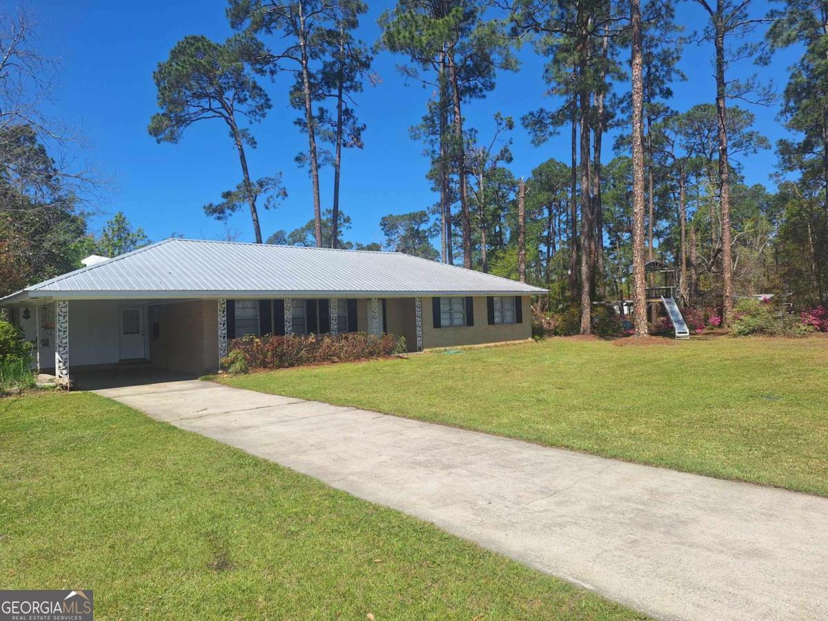 Very Spacious 4 bed/2 bath home on .83 Acres walking distance to restaurants and shopping. The kitchen has stainless steel appliances, new cabinets, concrete counters, farm style sink, and open floor plan to living room. Sunroom is bright and airy to enjoy sitting and relaxing. The yards are beautiful this time of year with the azaleas blooming, grape vines, and blueberry bushes. Call Stephanie Capalbo @ GA DreamWorks Realty for more info 912 286 7292