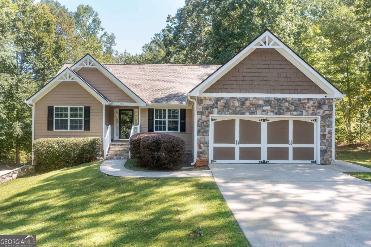 Beautiful one-level ranch home on a full daylight basement with endless potential! This well-maintained home offers 3 bedrooms, 2 full baths, and a split bedroom floor plan designed for comfortable living and entertaining. Inside you will find hardwood floors in the main living areas, tile flooring in the baths and laundry, and carpet in the bedrooms. The inviting foyer opens to a formal dining room and a breakfast room off the kitchen. The spacious kitchen features granite countertops, craftsman style cabinets, ungraded appliances, pantry, and a view into the vaulted great room. The large family room boasts a stunning rock fireplace, vaulted ceilings and an open concept design. The private owner's suite showcases a tray ceiling, and a spa-like bath with double vanity, solid surface counters, garden tub, separate shower, and tile floors. Secondary bedrooms are bright and generously sized. Laundry on the main level includes cabinets for storage and large countertop perfect for extra workspace! Enjoy outdoor living on the extended and oversized back deck which is partially screened-in, with vaulted ceiling and ceiling fans, for year-round enjoyment plus features a larger uncovered deck perfect for grilling or hanging out which is overlooking a private, wooded backyard. The full daylight basement offers both interior and exterior access, is stubbed for a future bath and features a second driveway with ample parking. Ideal for a boat, RV, or extra vehicles. Additional features include: Two-car garage, Hardwired alarm system, New roof in 2022, Exterior painted in 2024, No HOA / No subdivision! This property offers privacy, practicality, and potential all in one!