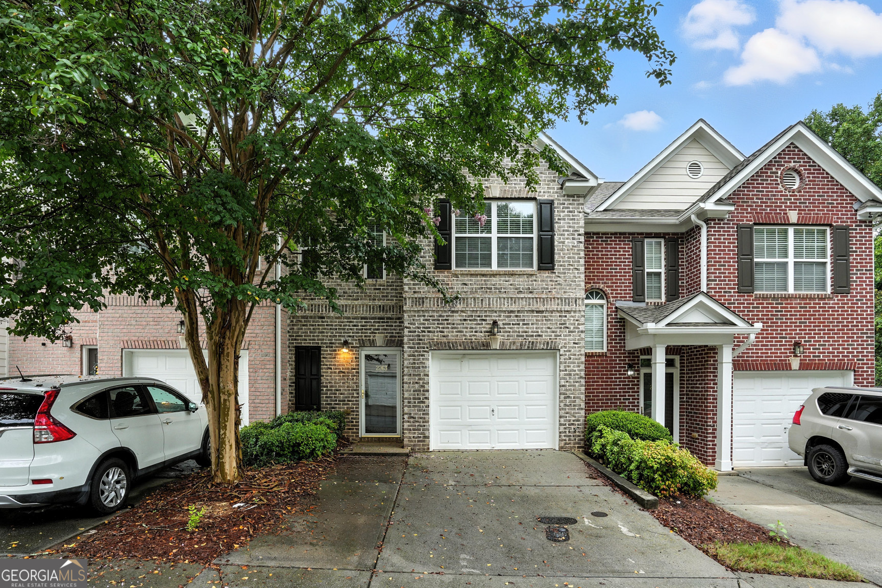 Welcome to 2263 Leicester Way SE, a beautifully maintained 3-bedroom, 2.5-bath townhome in the gated Brighton Village community. For a limited time, the seller is offering a fantastic incentive - Choose between six months of HOA dues paid plus $2,000 toward your closing costs or a full year of HOA dues paid in full. On top of that, the home comes with a one-year warranty from 2-10 Home Buyers Warranty, covering all major systems and appliances for added peace of mind. Located just a short drive from Grant Park, Zoo Atlanta, East Atlanta Village, and I-20, this home offers easy access to some of Atlanta's most popular spots. Nearby you'll also find Grant Park Market, Publix at Madison Yards, and a wide range of restaurants, coffee shops, and local favorites. Inside, the home features hardwood floors on the main level, a spacious open layout, and a cozy living area with a fireplace. The kitchen offers plenty of cabinet and counter space, making it perfect for both everyday living and entertaining. Upstairs, the large primary suite includes a walk-in closet and a private bath with double vanities, a soaking tub, and a separate shower. Two additional bedrooms, a full bathroom, and laundry are also located on the upper level. The private backyard provides a peaceful outdoor space, great for grilling or relaxing. The community also features a pool, playground, and secure gated entry. This home offers comfort, convenience, and value in one of Atlanta's most desirable areas. Don't miss out on this limited-time offer and added warranty coverage!