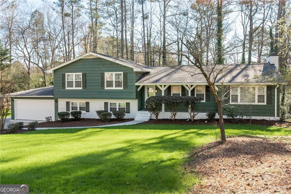 Charming Split-Level Ranch in Sought-After Pope High School District! Welcome to your private retreat in East Cobb! This beautifully maintained home sits on a generous 0.75-acre lot and offers the perfect blend of comfort, space, and convenience. Step inside to discover a light-filled kitchen with warm wood cabinetry, plenty of counter space, and a cozy eat-in area - perfect for casual meals. The separate dining room is ideal for entertaining guests or hosting holiday dinners. Unwind in the inviting screened porch, which overlooks a peaceful, wooded,fenced backyard, or soak up the sun on the additional deck-both perfect spots for morning coffee or evening relaxation. The large, private backyard offers ample space for play, gardening, or future expansion. Downstairs, you'll find a finished basement with a media room-ideal for movie nights, a playroom, or a home gym. Located just minutes from Murdock Elementary, this home offers quick access to top-rated schools, major highways, downtown Atlanta, the airport, and all the shopping and dining of East Cobb Avenues. Don't miss your chance to own this peaceful and perfectly located East Cobb gem-schedule your showing today!