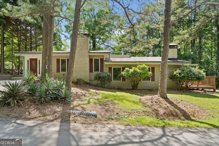 Welcome to your peaceful lakefront retreat, nestled in a quiet cove just minutes from Towne Lake's heart. This charming ranch-style cottage sits on a partially finished basement, blending modern updates with cozy character.  A new single-slip dock awaits, making lake life easy to enjoy - just a short, level four-minute walk from your back door. The updated home has a renovated kitchen with new appliances. Fresh paint is everywhere, and the refinished hardwood floors bring warmth and style. The oversized primary suite is a true sanctuary, boasting a vaulted, beamed ceiling and an updated ensuite bath.  The finished bonus room in the basement offers flexible space for a home office, media room, or guest area. Step outside to a brand-new deck and fenced backyard, perfect for entertaining or soaking in the lake's serenity.  This property is ideal for a full-time home or a weekend getaway. It provides a great retreat while still being convenient. Just minutes from Towne Lake's shopping and dining, you get the best of both worlds. Enjoy calm lakefront living and quick access to everything you need. To access dock area please enter gated area across the street, walk down a very short way to first path on the right and dock will be directly ahead.  This home is ready to welcome you.