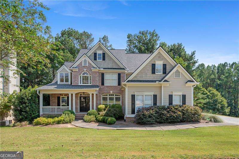 Welcome to 107 Thorncliff Landing, a well-kept home in the popular Bentwater community of Acworth, GA. With great curb appeal, a three-car garage, and a covered front porch, this home is both inviting and practical. Inside, you'll find a two-story foyer, hardwood floors, and a dining room with classic details. The great room has tall ceilings, a brick fireplace, and big windows with views of the trees. The kitchen includes Quartzite countertops, black stainless steel appliances, wood cabinets, and double ovens. There's also a breakfast bar, pantry, and sunny eating area. French doors lead to a bright sunroom overlooking the backyard. The main-level primary bedroom has a tray ceiling and a large bathroom with two sinks, a soaking tub, and a separate shower. Upstairs, there are three more bedrooms with plenty of closet space. The finished basement adds even more space with a big recreation room, wet bar, bedroom, full bath, and a flex room for exercise or hobbies. A workshop provides room for projects and storage. Outside, enjoy the private wooded view from the back deck. The home also has a newer roof and gutters with guards. Living in Bentwater means access to amazing neighborhood amenities like 5 swimming pools, 12 tennis courts, 4 pickleball courts, basketball courts, playgrounds, walking trails, and the Bentwater Golf Course (membership required). The home is in the top-rated North Paulding school district and is close to shopping, dining, and major roads. Schedule your showing today to see everything this home has to offer!