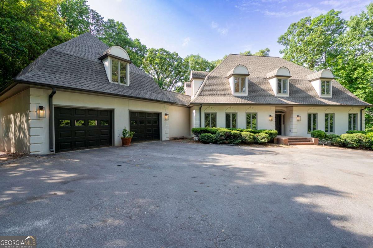 IT'S THE ADDRESS!!!!!!! Located on one of the most prestigious streets in East Cobb, and overlooking the hole at Atlanta Country Club Golf Course is 410 Papermill Road. One (or two) can enjoy one-level living, if desired, with lots of space for others on the upper and terrace levels. Total of five bedrooms and four and on half baths. From the moment you enter, you are drawn to the light and panoramic view of the Atlanta Country Club Golf Course. This home begs to host a party, with it's capacious, flowing rooms. All bedrooms and closets are generous in size and each bathroom is equipped with double sinks. The Terrace Level has a private viewing room (equipment not included), wine storage, an abundance of storage, a bedroom with a view, and a walk-out game room with a view. This home has been renovated for you. A commodious kitchen with new appliances and spaces for anything most of us can imagine is connected to the garage by a huge work area with more storage, laundry, counter space, and pantry.