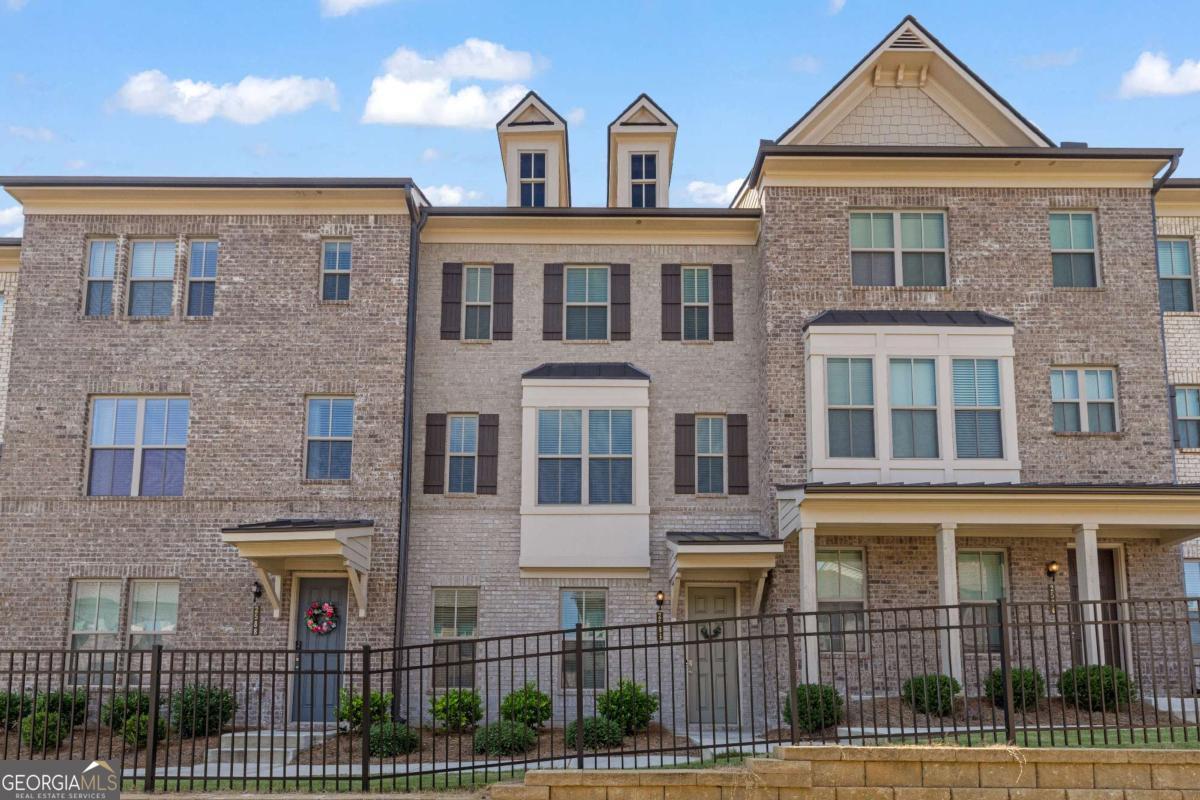 Welcome to this modern 3-level townhome in a luxury gated community within the sought-after Dunwoody School District. Featuring 4 bedrooms, 3.5 bathrooms, and 9' ceilings, this home is designed for both style and comfort. Highlights include hardwood flooring on the foyer and main level, quartz countertops, stainless steel appliances, a double oven, and a rear-entry 2-car garage. The open concept main level boasts a spacious living area, half bath, and a walkout deck perfect for relaxing or entertaining. Upstairs, you'll find the oversized primary suite with a spa like bathroom, plus two additional bedrooms, the laundry room, and another full bath. The finished lower level offers a private bedroom with a full bathroom and easy garage access. This community offers resort style amenities: a sparkling pool with private cabanas, bocce court, event lawn, clubhouse, dog park, playground, walking trails, fire pits, and ample guest parking. Ideally situated near I-285 and Peachtree Industrial Boulevard, you're just minutes from Buckhead, Perimeter, downtown Atlanta, the airport, and the culinary hotspot Buford Highway. With newer construction, you'll enjoy peace of mind knowing all major systems are up to date, while the oversized primary suite and thoughtful layout create the ultimate in luxury living.