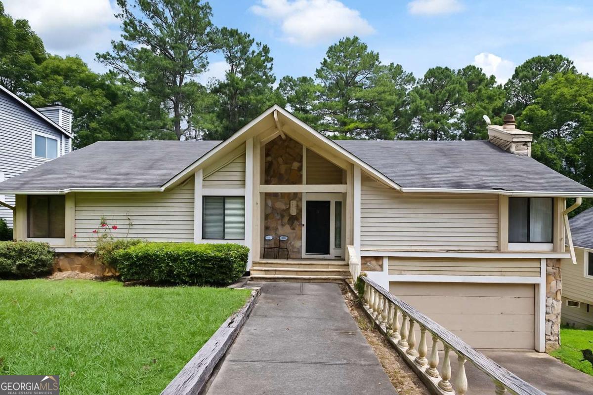 This spacious home is located in one of East Cobb's most sought-after neighborhoods, offering an incredible opportunity to make it your own. The main level features a master suite with a beautifully renovated, on-trend bathroom plus a second bedroom for convenience. Two additional bedrooms are located on the lower level, providing flexible space for family, guests, or a home office. The heart of the home is the large open family room with soaring vaulted ceilings and an abundance of natural light. Step outside to enjoy a fenced backyard with a sparkling pool, perfect for entertaining, along with a newer top deck for relaxing outdoors. With solid bones and great space, this home offers endless potential. While it does need some repairs-including chimney siding, retaining wall work, and cosmetic updates-it is attractively priced with these improvements in mind. Don't miss your chance to own in the highly desirable Indian Hills Country Club community-this is the perfect opportunity to invest in a prime location and create your dream home!