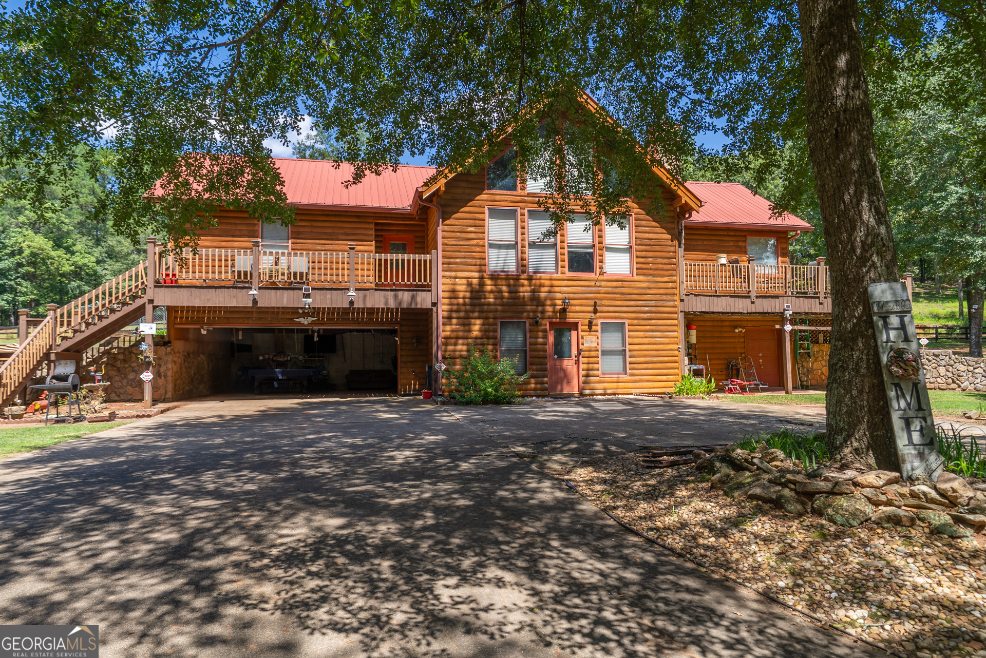 Escape to your own private retreat with this stunning 3-bedroom, 3-bathroom log cabin nestled on 17.62 acres of picturesque land backing up to the serene Alcovy River. Designed with natural beauty and tranquility in mind, this home blends rustic charm with modern comforts-ideal for those seeking peace, space, and the perfect setting for horses or outdoor living. Step inside to find warm wood finishes, an open-concept living area, and plenty of natural light. The spacious floor plan includes a cozy stone fireplace, a well-appointed kitchen, and generous bedrooms with plenty of storage. Outside, the land speaks for itself. Most of the property is fully fenced-perfect for horses-and features both a 16x16 pole barn and a dedicated horse barn for your equestrian needs. Whether you're looking to ride, garden, entertain, or simply enjoy nature, this property offers endless possibilities. With direct river access, expansive views, and ample space to roam, this one-of-a-kind property is more than a home-it's a lifestyle.