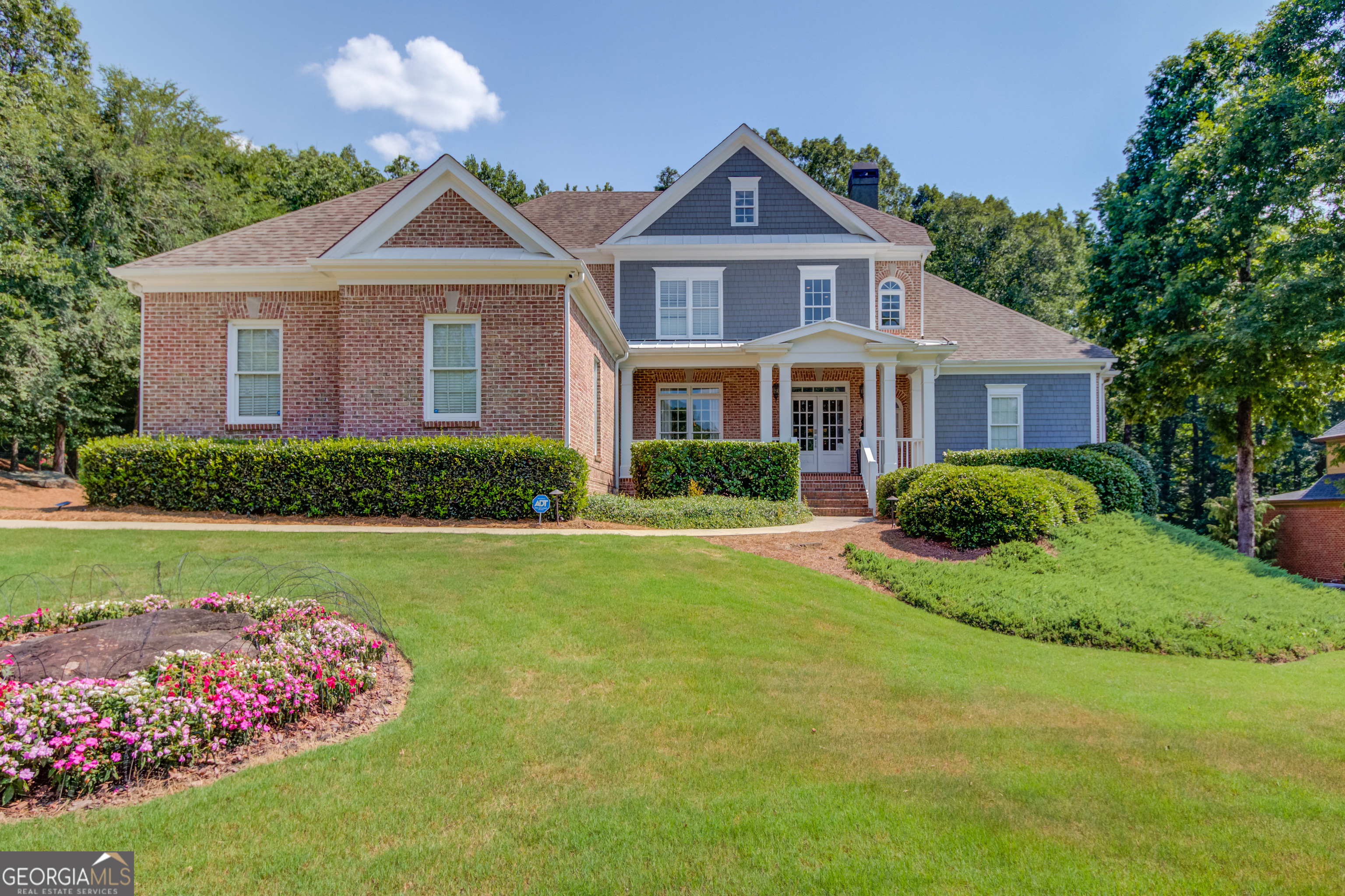 Stunning and move-in ready 4 bedroom, 4.5 bathroom home in Hoschton's Chateau Forest community located in the Mill Creek High School District. The main level features a covered front porch, 2-story entry foyer, dining room with butler's pantry, fireside living room with coffered ceilings and built in bookcases, eat-in chefs' kitchen with quartz countertops, ss appliances, walk in pantry and a fireside sitting room. The owner's suite is also on the main level and features a double tray ceiling, double vanity, soaking tub, and separate shower and large custom walk-in closet with a laundry feature. There is also a full laundry room and half bath on the main level. The upper level features 3 secondary bedrooms and 2 full bathrooms (1 ensuite and 1 jack-n-jill). The finished terrace level features a bar, game room, home theater, gym, flex room and full bathroom. Outside enjoy your own private saltwater pool with a waterfall, fire pit, and tree house tucked just inside the woods in a private 0.94 acre fenced lot. The screened in deck off the main level and covered patio off the terrace level make entertaining a breeze. Conveniently located close to the interstate, schools, shopping, dining and entertainment!