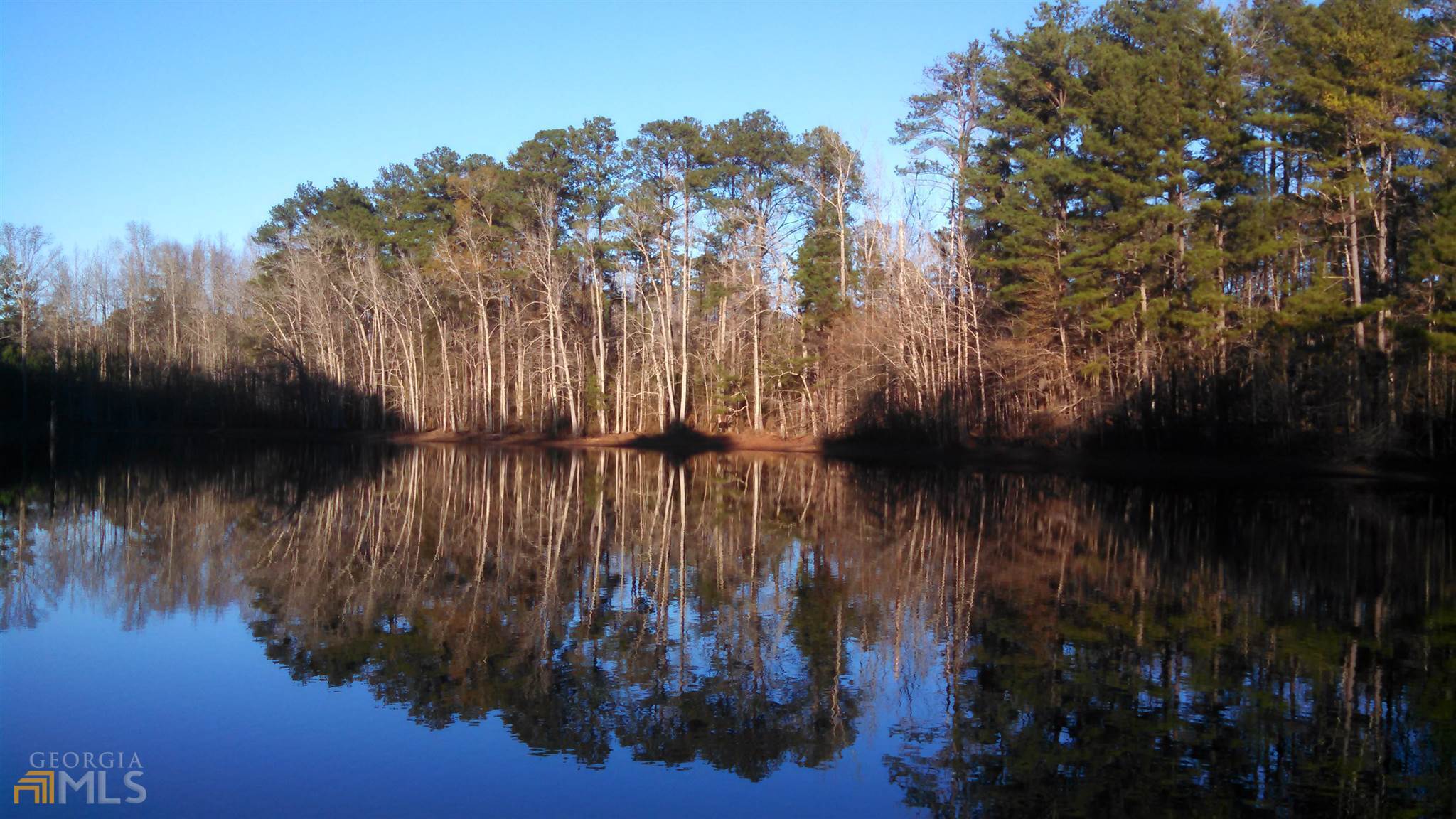 Lake front lot in established subdivision. One of only two lake lots in the subdivision ever offered for sale. All city utilities, minimum heated area and other restrictions apply. This lot is inside city limits of Griffin.