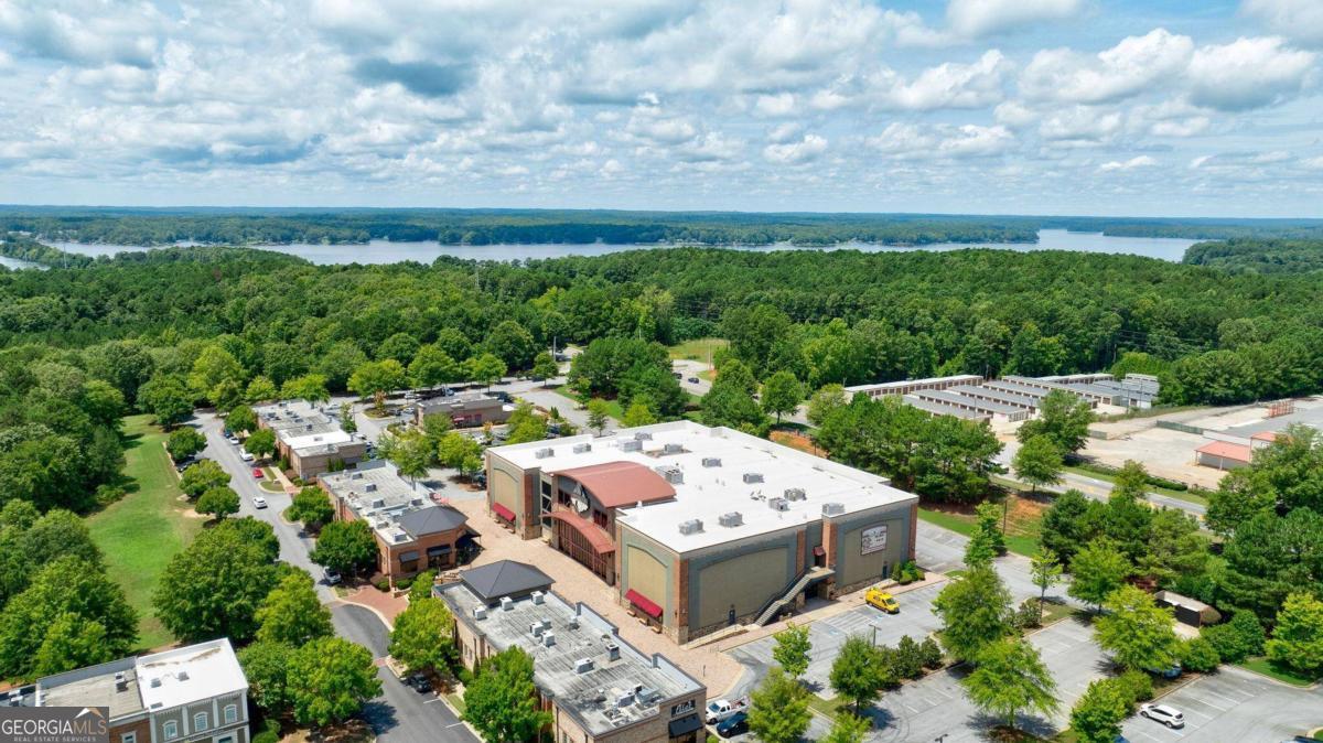 Don't miss out on this opportunity to own a major landmark in the Lake Country and secure a place in Lake Oconee's growth for years to come!    Parkside Main 8 Movie Theater is located next to Publix in the rapidly growing Lake Oconee market.  Featuring over 50,000 SF on 4.31 acres in Lake Oconee Village, this open and fully operational 8 cinema theater has 915 theater seats over two levels AND all FFE is included in the sale!  Continue to operate as a theater, add additional entertainment and food options, or redevelop into one of the many other allowed uses in this flexible mixed-use zoned property.         The main level features 36' ceilings in the impressive entry with expansive floor to ceiling windows overlooking the courtyard of Parkside Main.  The atrium style entry has the ticketing and concession counter that connects to a full-service kitchen.  The kitchen location allows for easy access to the concession counter, the theaters via a pass-through serving area along the hallway while a dumbwaiter provides food access to the second level. The second level, accessible by elevator or open stairs, leads to a full bar with seating, 2 private event rooms and balcony access seating for all 8 theaters.  Customer restrooms are located on both floors.    This versatile building opens up a world of possibilities.  Let your creativity run free as you explore adding additional entertainment options such as Laser-Tag, Bowling, Pickle Ball, or Arcade Games.  Expand the menu and utilize the full kitchen to provide a full lunch and dinner service.  There are endless options.   Located at the entrance of Reynolds Lake Oconee, Lake Oconee Village is a 600-acre master-planned mixed-use development with a variety of shops and professional services in one convenient location. With nearly 100 active businesses, Lake Oconee Village provides a true mixed-use environment offering everything from entertainment and boutique shopping to a wide variety of dining options.