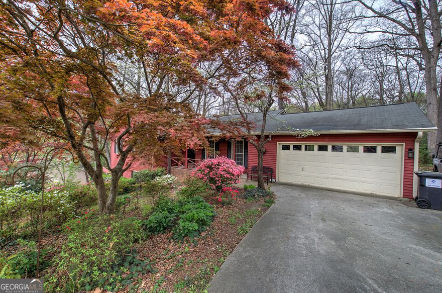 RANCH home with a PARK-LIKE SETTING in the heart of EAST COBB!  The floorplan offers an entrance foyer which leads to Family, Dining and Kitchen Areas. The master bedroom IS OVERSIZED WITH A SITTING ROOM, features a gas fireplace to keep you warm, large marble jacuzzi-whirlpool tub. The updated gourmet kitchen boasts White CABINETS, SOLID SURFACE COUNTERS & STAINLESS REFRIGERATOR along with a convenient breakfast room. The spacious master suite offers a Fireplace, CUSTOM WALK-IN CLOSET along with a Jacuzzi Marble BATHROOM with a double vanity and walk in shower. Two additional bedrooms are on the main level and share a GUEST BATHRROOM WITH TILE. There's more room to live, work and play in the FINISHED BASEMENT which offers enough space for a recreation room, LARGE LAUNDRY ROOM IN BASEMENT, wood burning fireplace, patio with double doors leading to outside, office and there's a separate bedroom/bonus room. The unfinished space offers plenty of room for STORAGE and a WORKSHOP. Enjoy entertaining your family and friends on your large back COVERED, SCREENED deck that overlooks a BEAUTIFULLY LANDSCAPEED backyard! Some additional upgrades and features include a TWO CAR GARAGE with a garage door opened, HARDWOODS on the entire main level. PRIVATE front and backyard. You can't beat the location-minutes from the schools, Truist Park, The Battery and the interstate. This is one of those RARE FINDS where PRIDE IN OWNERSHIP SHOWS! All you have to do is turn the key and move right in!