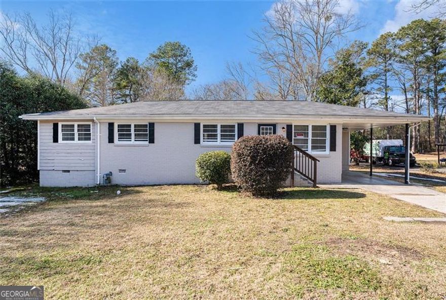 Charming 4-bed, 2-bath single-story home with an attached 1-car carport and a deck in the fenced backyard. The home features vinyl plank floors in the common areas and carpet in the bedrooms. A spacious dining room area is located next to the kitchen, which offers white cabinets, granite counters, stainless steel appliances, and a convenient pass-through kitchen island. The laundry room is just off the dining room, with access to both the backyard deck and carport. The kitchen also features a window overlooking the backyard. The guest bath has a tub/shower combo, and the primary bedroom boasts an en-suite bath with dual closets for added storage.