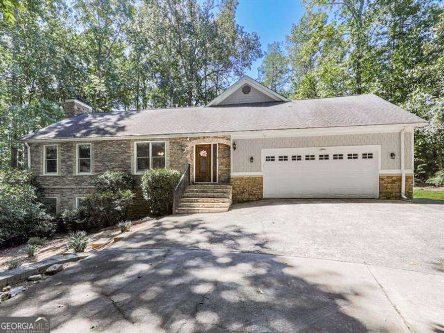 Nestled on over 2 acres of wooded privacy, this solid and inviting home offers the perfect blend of space, charm, and convenience. The open floor plan flows beautifully, starting with a warm and welcoming kitchen featuring solid wood cabinetry, stainless steel appliances, and granite countertops. A huge breakfast/dining room provides plenty of space for gatherings, while the massive family room impresses with its gas log fireplace, soaring vaulted ceilings, and access to a private back deck overlooking the serene setting.  Upstairs, you'll find a versatile loft/office and a stunning master retreat with its own private balcony. The spa-like en-suite bath features a clawfoot soaking tub, tiled walk-in shower, and double vanity. Two additional spacious bedrooms are located on the main level along with a covered, screened porch perfect for enjoying the outdoors year-round.  The finished basement expands your living options with a large common area, additional bedroom and full bath! Outside, a fenced backyard provides plenty of room to roam, while the long winding driveway crosses a tranquil creek, setting the tone for this peaceful retreat.  Located just seconds from Milton, Alpharetta, and Cumming parks, shopping, and activities, this home is a true showstopper-offering the best of privacy, space, and location.