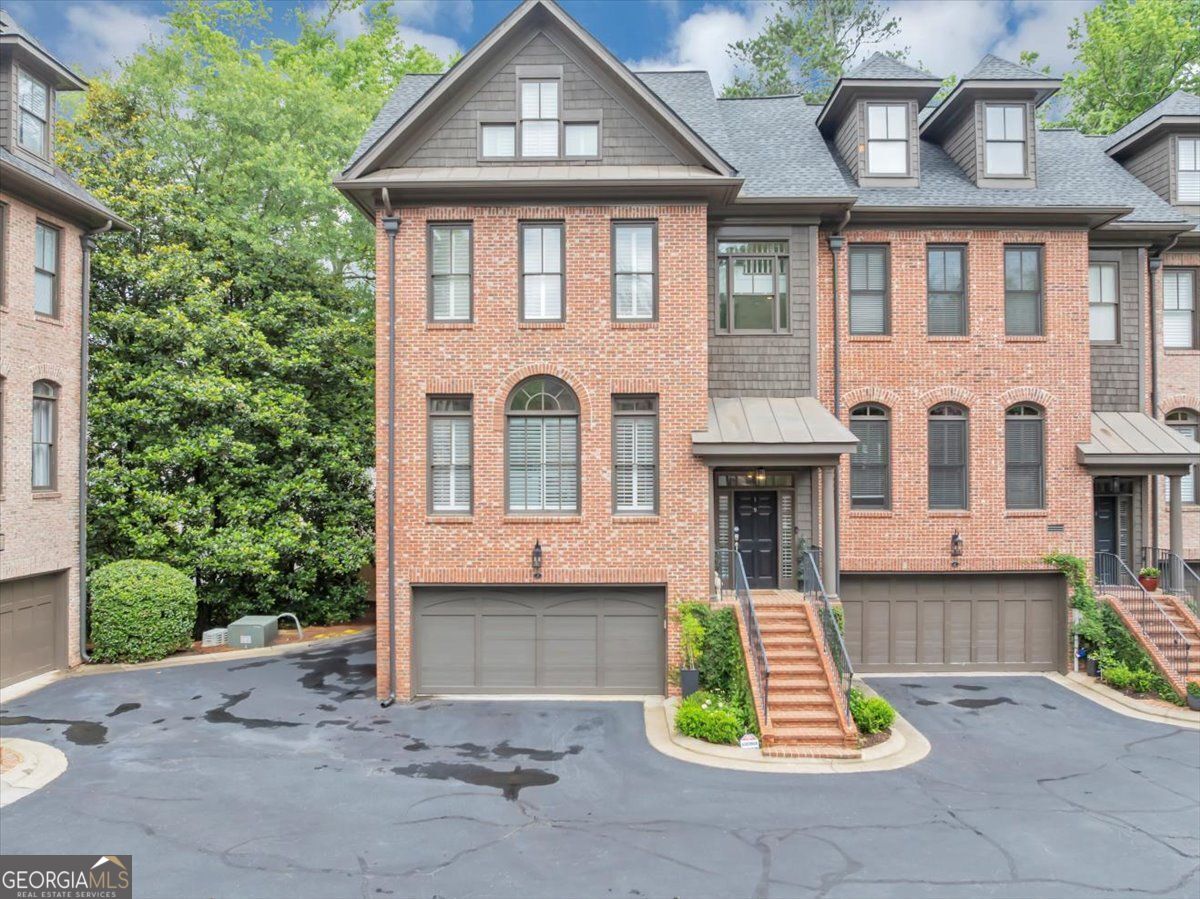 This expansive brownstone has the largest floorplan in the community and is filled with charming custom designs and finishes. Walk to Chastain and over a dozen restaurants and shops. 4 bedrooms, 4 1/2 baths with a loft. Beautifully remodeled with an elevator and a 2 car garage. Plantation shutters, custom hardwoods, ceilings, and designer fixtures throughout! Two fireplaces and an abundance of outdoor living space with electric awning. Custom closets, marble, quartz, built in bookshelves and an end unit. Everything has been replaced and designer quality. A must see in one of the most desired communities in the area.