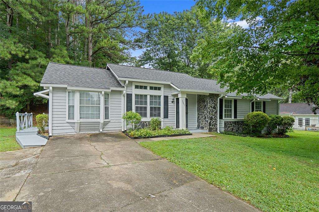 4.75% Interest Rate for a limited time! Or receive $9500 in closing costs! Welcome Home ATL to this charming 3-bedroom, 2-bath ranch nestled in a quiet, well-loved neighborhood. The open floor plan flows effortlessly from the great room to the dining area, while a separate living room adds extra flexibility for work or relaxation.The kitchen shines with granite countertops, tile flooring, white cabinetry, and stainless steel appliances. Both bathrooms are updated with matching tile and granite finishes, offering a clean and cohesive look. Out back, enjoy a spacious yard and large storage shed-perfect for weekend projects or extra storage. With a layout built for everyday living and a location close to schools, parks, and shopping, this one is not to be missed!