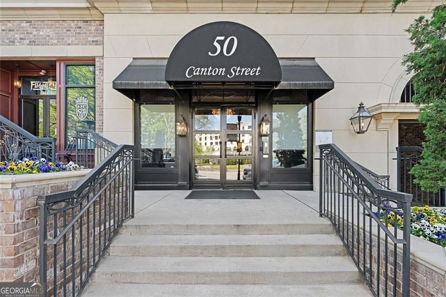 Experience LUXURY ONE LEVEL LIVING in the heart of downtown Alpharetta!! Enjoy walking to shops, restaurants, farmers market and year round events.  As you enter this beautiful Unit you will find an open concept with a tons of natural sunlight. The chefs kitchen boast of quartz countertops and high end appliances such as a Wolf gas range and Sub-Zero refrigerator. Off the kitchen you will find an oversize walk in pantry. The open-concept living and dining area flows seamlessly to a private balcony complete with a built in grill, cozy fireplace and an electric screen you can let down to block sun, have privacy, while also making it enjoyable all year round. Perfect for relaxing. The beautiful primary bedroom also walks out to the private balcony.  You will find beautiful hardwoods throughout the unit. The primary has its own spa like bath and large walk in California type closet. The secondary bedroom is equipped with its own private bath for privacy.  This Unit is perfectly located on the second level which opens up to the beautiful park and amenities. The park includes a relaxing fountain, beautiful pavilion with fireplace, tv, and outdoor kitchen, perfect for hosting get togethers. The park also includes a green egg, bocci ball court, fire pit, herb garden, and dog park.  Teasley place also has a fully equipped gym, and a gated, secure, parking garage with 2 designated parking spaces. This unit parking spots come with an EV charger, and your own climate control storage unit. Teasley Place is a one of a kind in Alpharetta and you will love this resort style living.  The HOA includes Premium tv package with all channels, 50 Hours of cloud DVR storage, high speed internet, trash, and concierge.