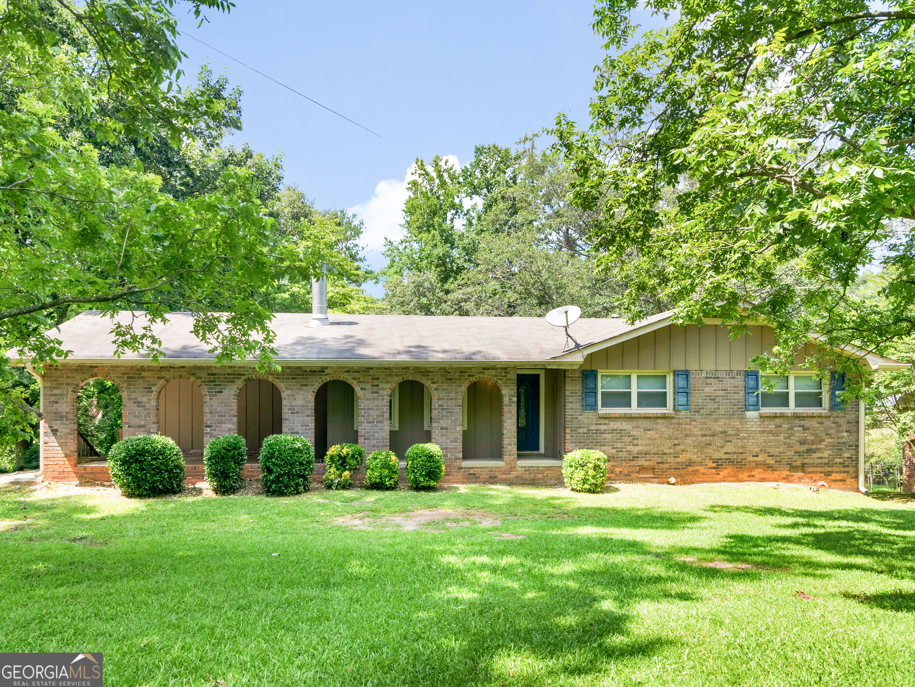 Charming and full of character, this 3-bedroom, 1.5-bath, four-side brick home sits on a spacious corner lot and offers comfort and convenience in a peaceful setting. Step into the inviting living room where a cozy wood-burning fireplace creates a warm, welcoming atmosphere. The eat-in kitchen provides the perfect space for casual dining and everyday living. It features a walk-in pantry with lots of shelves for food storage and extra space for storing small kitchen appliances. Downstairs, a full basement-partially finished-offers additional living space, ideal for a den, game room, or home office. Enjoy quiet mornings or evening gatherings on the generous refurbished back deck that overlooks a beautiful backyard with mature trees and blooming hydrangeas. Additional highlights include an attached carport, classic brick exterior, and timeless curb appeal. Don't miss the opportunity to make this delightful home your own! This home is convenient to I-675 and shopping and dining options in Stockbridge!