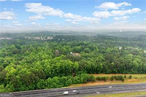 Prime 27.2-Acre Investment Opportunity - Exceptional Commercial Development Potential. Strategically located near the intersection of Sixes Road and Main Street, this 27.2-acre property offers a rare opportunity for commercial development in fast-growing Cherokee County. With approximately 2,529 feet of road frontage along North Rope Mill Road and 376 feet along I-575 on Tract A (7 acres), this property boasts outstanding visibility and accessibility. Currently zoned Agricultural, the land is identified for Commercial Development under the county's future land use plan-making it an ideal site for a wide range of investment projects. Key Highlights: Just 1.4 miles to WellStar Cherokee Health Park. Only 0.7 miles to Home Depot, 0.9 miles to Kroger Grocery and Pharmacy. Approximately 4.7 miles to Downtown Woodstock, GA, 3.1 miles to Holly Springs, GA. Walk to Olde Rope Mill Park. Excellent topography with no floodplain. High traffic counts and strong area growth. This parcel is being sold as-is. Showings by appointment only. Whether you're an experienced developer or a savvy investor looking for a foothold in one of Cherokee County's most dynamic corridors, this property presents unmatched potential.