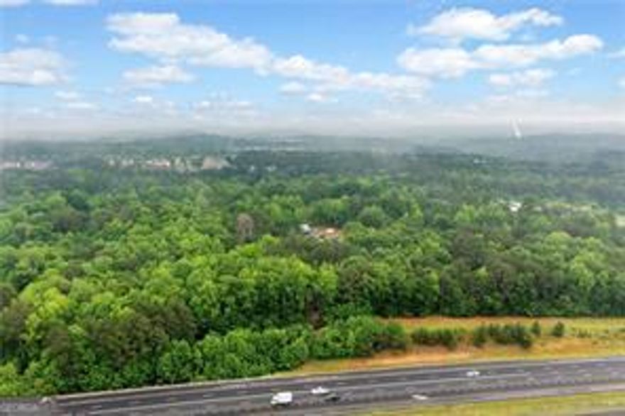 Prime 27.2-Acre Investment Opportunity - Exceptional Commercial Development Potential. Strategically located near the intersection of Sixes Road and Main Street, this 27.2-acre property offers a rare opportunity for commercial development in fast-growing Cherokee County. With approximately 2,529 feet of road frontage along North Rope Mill Road and 376 feet along I-575 on Tract A (7 acres), this property boasts outstanding visibility and accessibility. Currently zoned Agricultural, the land is identified for Commercial Development under the county's future land use plan-making it an ideal site for a wide range of investment projects. Key Highlights: Just 1.4 miles to WellStar Cherokee Health Park. Only 0.7 miles to Home Depot, 0.9 miles to Kroger Grocery and Pharmacy. Approximately 4.7 miles to Downtown Woodstock, GA, 3.1 miles to Holly Springs, GA. Walk to Olde Rope Mill Park. Excellent topography with no floodplain. High traffic counts and strong area growth. This parcel is being sold as-is. Showings by appointment only. Whether you're an experienced developer or a savvy investor looking for a foothold in one of Cherokee County's most dynamic corridors, this property presents unmatched potential.