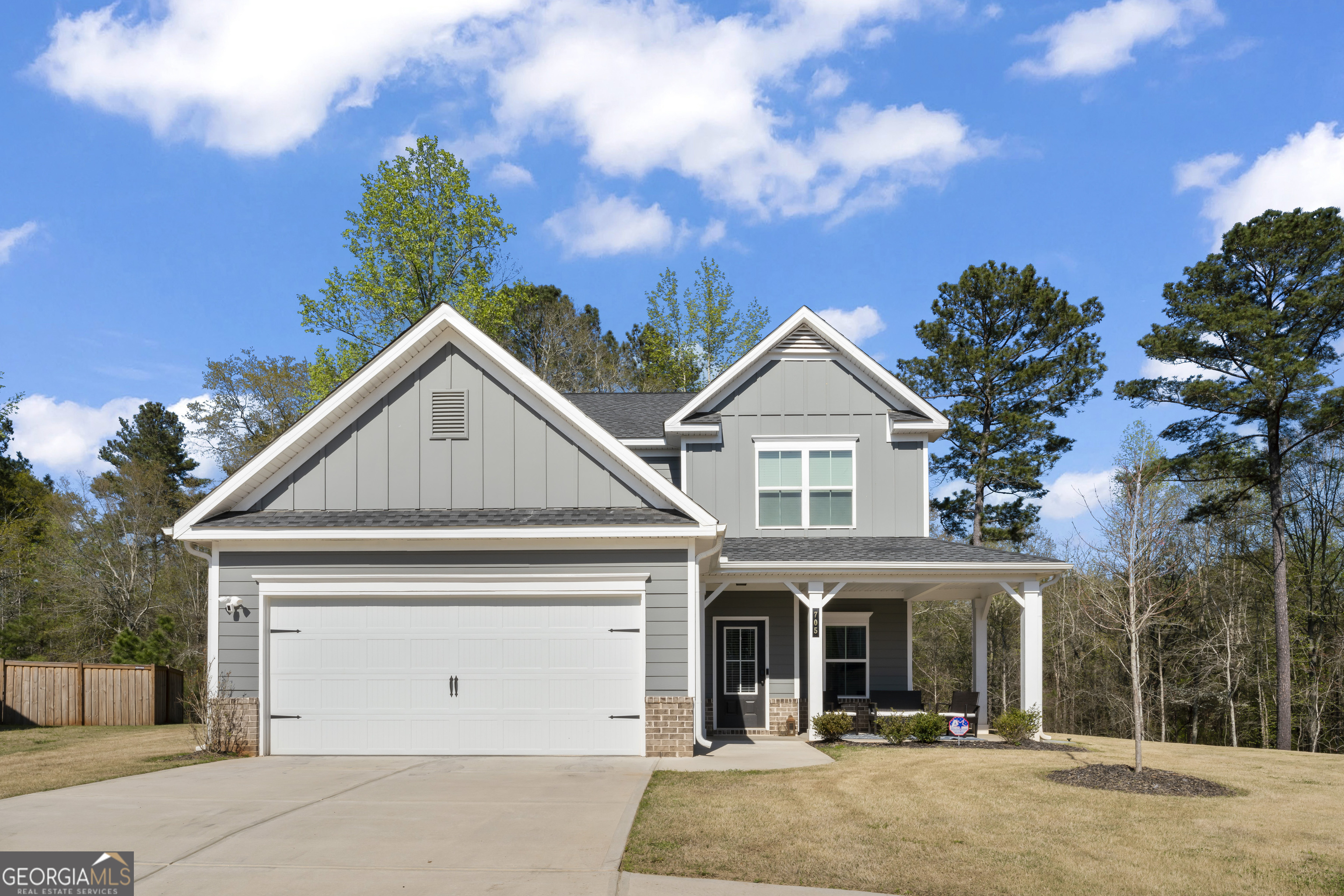Charming farmhouse style 4 bedroom 2.5 bath in the Stonecreek subdivision of Monroe. The community features a swimming pool, playground and double sidewalks. The home is just a minute walk to the amenity areas. Both the front and back of the home feature covered porches and the lot is fenced in. Built in 2021, the 2141 square foot home is like new with many owner upgrades. Inside you will find an open floor plan with a separate dining area and southing neutral finishes. The kitchen features a breakfast bar, white cabinets, window sink and granite countertops. Upstairs you will find four bedrooms, hall bath and laundry room. One of the bedrooms features conferred paneled woodworking surrounding a neutral designer wallpaper mural. In the primary suite you will find 2 walk-in closets and an additional linen closet. The primary bath has separate his and hers sinks and separate shower and bath. The bathroom also has three large windows that allow light to dance on the new white and grey streaked marble tile floors. Close to everything in Monroe!