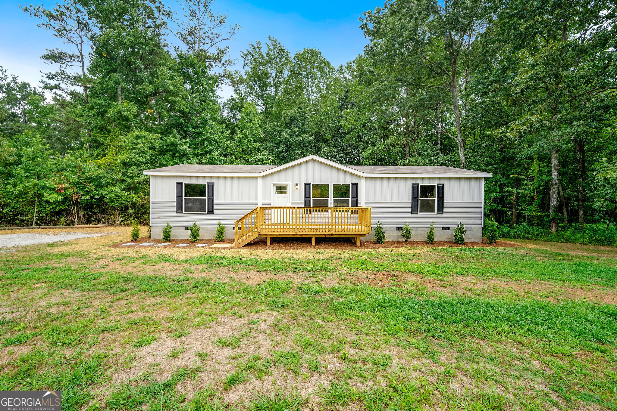 This brand new manufactured home offers space and style on an oversized lot. The home features luxury vinyl flooring throughout, a double vanity in the master bathroom, and a large kitchen island perfect for entertaining. The home is all electric, equipped with stainless steel appliances and a stylish vent hood. Spacious front and back decks allow you to enjoy your newly-landscaped property located down a quiet gravel road. Conveniently located close to all that both Villa Rica and Carrollton have to offer!