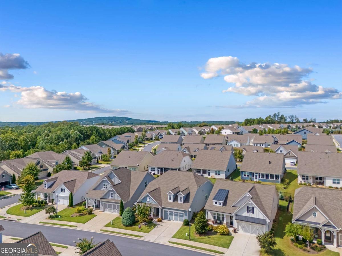 Welcome to this stunning 4-year-old home in one of Canton's most desirable active adult communities, where resort-style living meets everyday comfort. Just steps away from a walk-in pool, 17,000 sq. ft. clubhouse with endless activities, tennis, and pickle ball courts, you'll enjoy a vibrant lifestyle right outside your door. Inside, this thoughtfully designed home offers 2 bedrooms plus a versatile flex room, perfect for a home office, craft space, or guest retreat. The open floor plan is ideal for entertaining, featuring a fireside family room that flows seamlessly into the stylish kitchen with gray cabinetry, quartz countertops, and a huge walk-in pantry. Relax and unwind on the screened porch, overlooking beautifully manicured grounds enhanced by over $10,000 in additional professional landscaping. Every detail has been carefully chosen to blend function and beauty, creating a home that is both welcoming and low-maintenance. Don't miss the opportunity to experience this exceptional home and community-schedule your private tour today!
