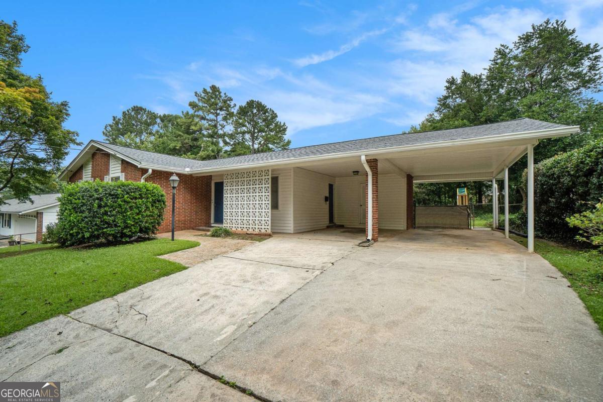 Charming Mid-Century Modern Ranch Retreat - Step into timeless style and comfort in this adorable mid-century modern ranch home, nestled in a serene, park-like setting. Enjoy morning coffee or evening breezes from the screened-in porch overlooking a beautifully established, fenced backyard-perfect for play, or peaceful reflection. Inside, you'll find gleaming wood floors, neutral-toned walls, and abundant natural light that creates a warm, inviting atmosphere throughout. The fully equipped kitchen comes with all appliances, including a washer and dryer, making move-in a breeze. The oversized carport and additional parking pad offer ample space for multiple vehicles-ideal for families or guests. This home blends classic charm with modern convenience in a location that feels like a private oasis inside perimeter just minutes to the City, downtown Decatur, CDC, and Emory.