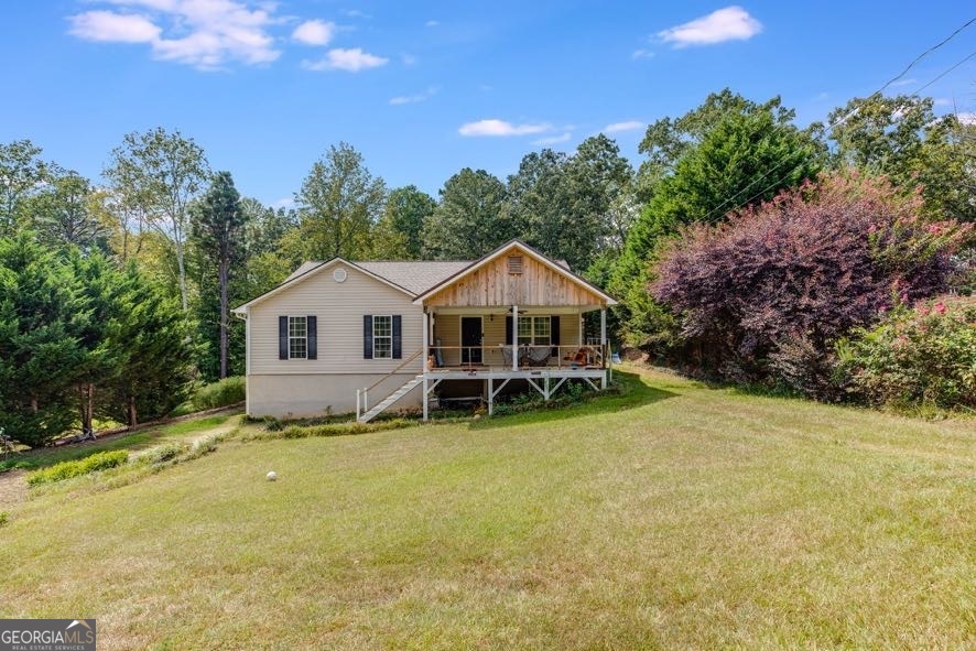 Raised Ranch with Rocking Chair Front Porch & Full Basement. Welcome home to this charming raised ranch located on a quiet dead-end street, offering both comfort and convenience. Inside, you'll find a cozy living room with fresh, updated paint colors and a spacious kitchen/dining area with tile flooring, plenty of cabinet space, and a gas stove. A separate laundry room is conveniently located right off the kitchen. The bedrooms are a good size with ample closet space. The primary suite features dual closets, double sinks, a soaking tub, a separate shower, and tile floors. The full unfinished basement provides endless opportunities to expand your living space, whether you envision a media room, additional bedrooms, or a workshop. There is a separate garage door, perfect for golf carts, lawn mowers, and other small vehicles. Additional highlights include: * Rocking chair front porch * Newer roof * Natural gas for stove, heat, and water heater (cook and heat even during power outages!) * City water and trash services. This home is just minutes from a gas station, Tanner Medical clinic, and offers quick access to I-20 and downtown Bremen. Don't miss this home with great potential in a convenient location, offered at under appraised value!